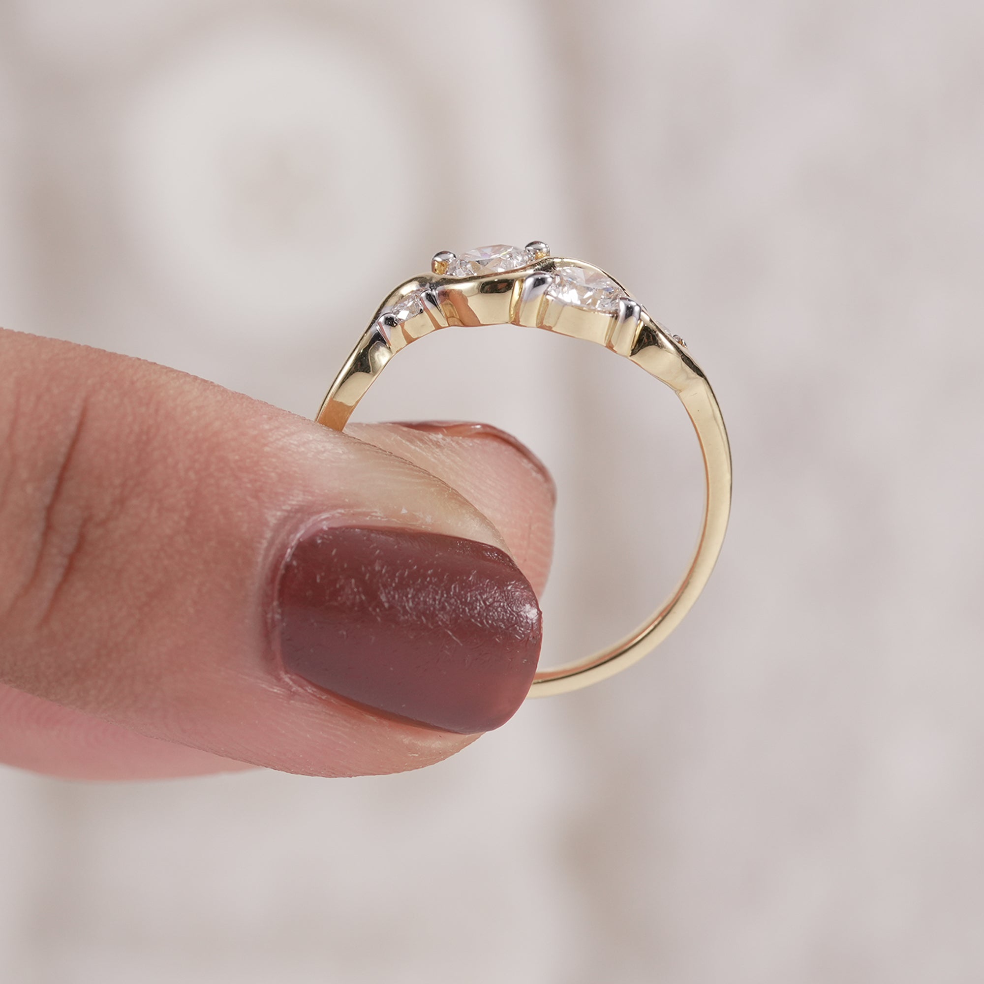 Women's curved diamond wedding band in yellow gold.