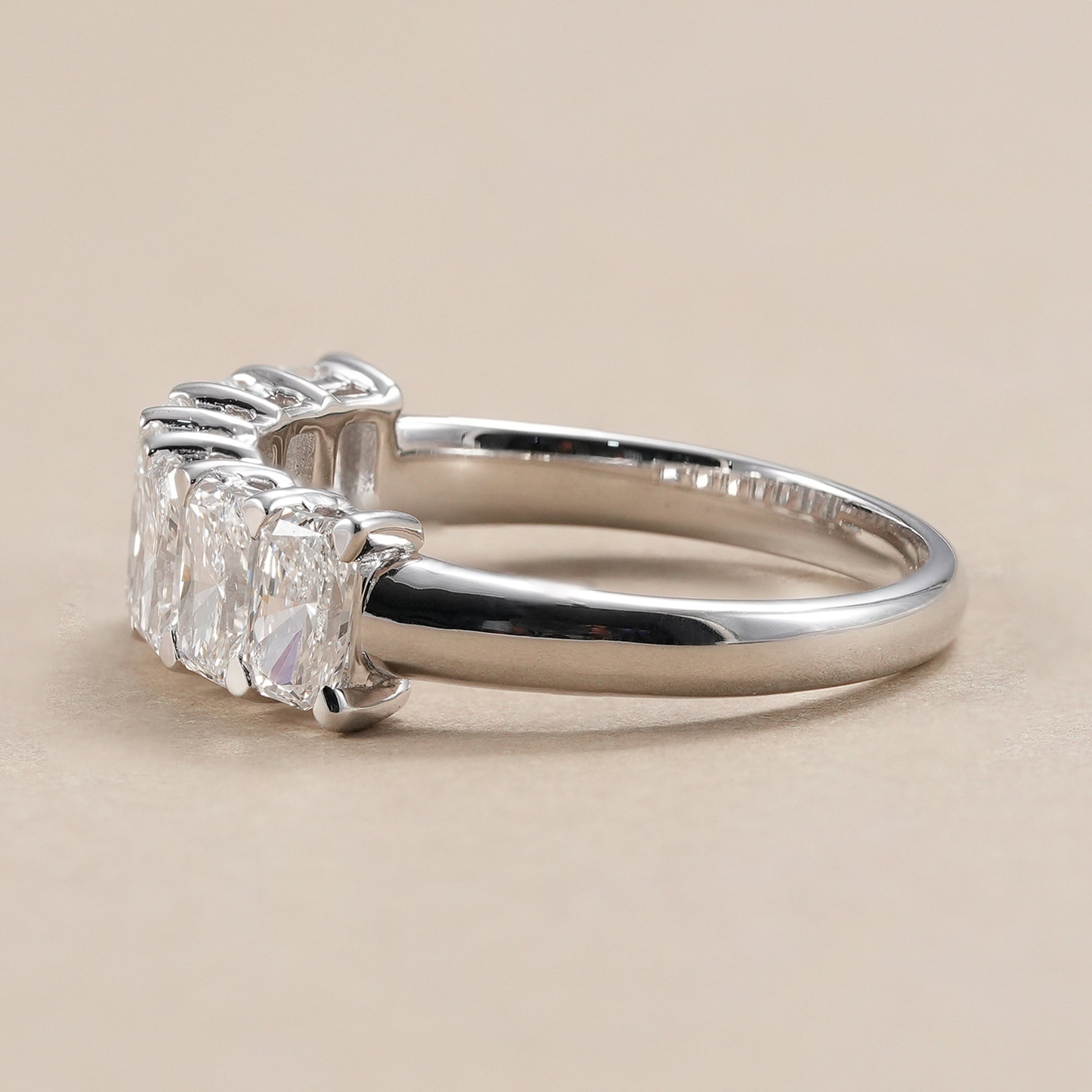 Radiant cut lab grown diamond eternity band with shared prong setting.