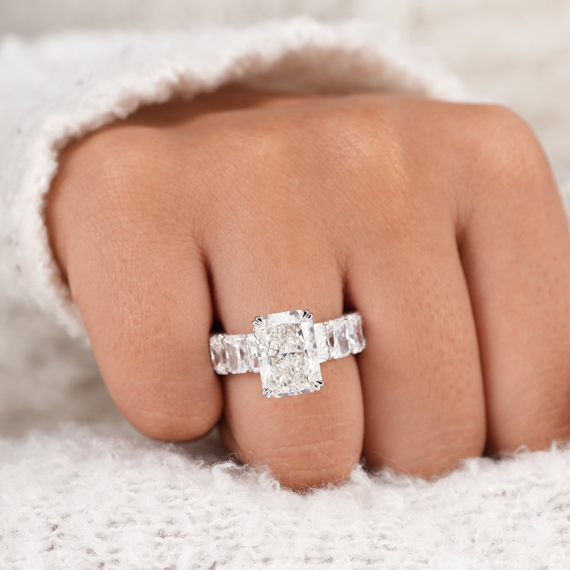 Four prong radiant engagement ring with radiant side diamonds