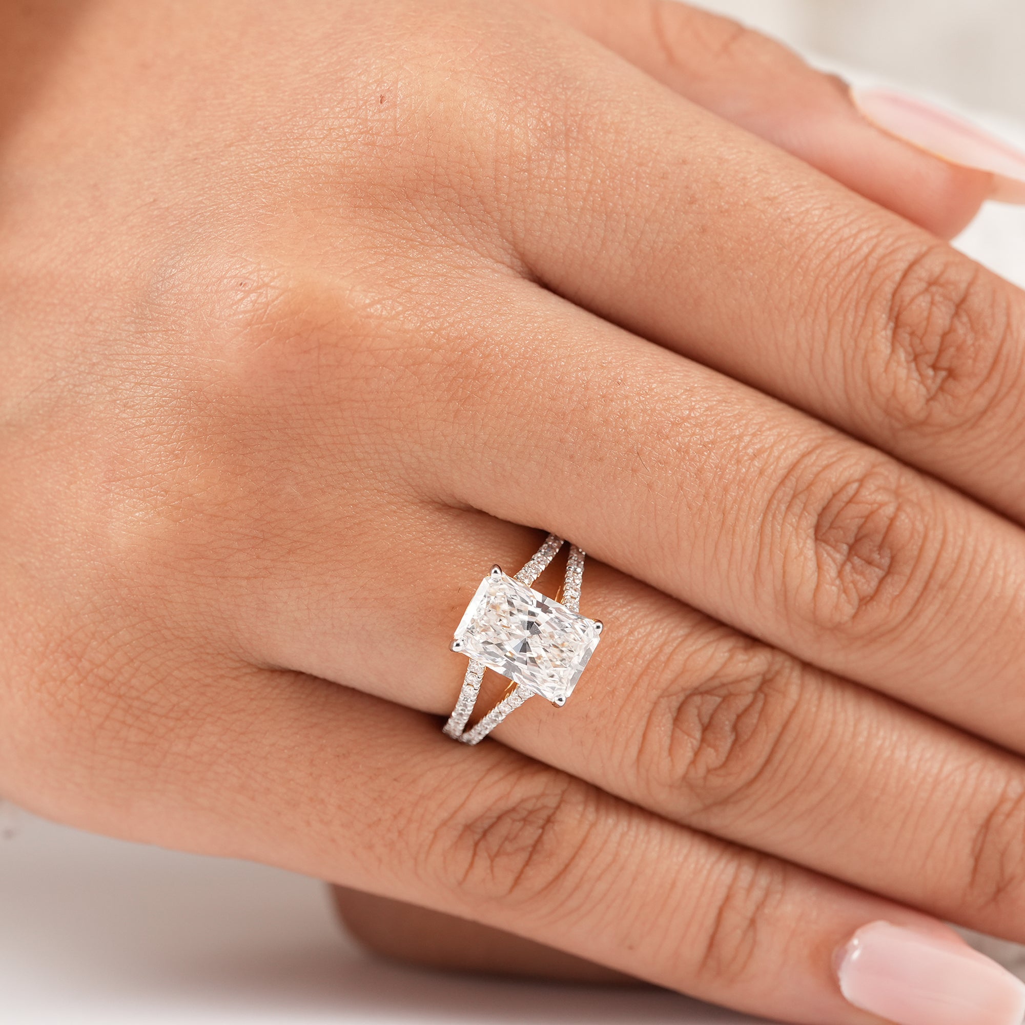 Radiant cut diamond ring with sparkling split pavé band