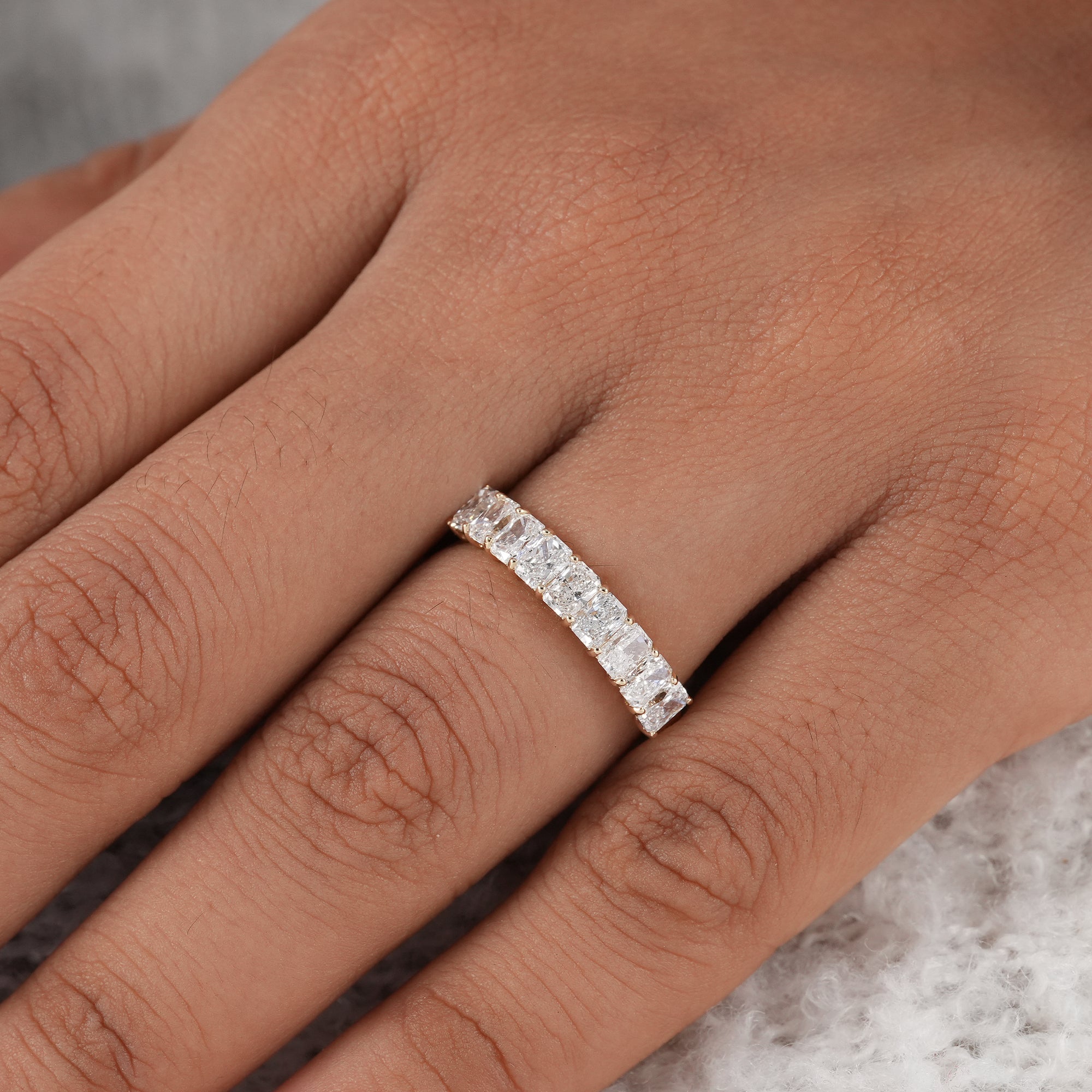 Radiant cut half eternity diamond band in solid gold.