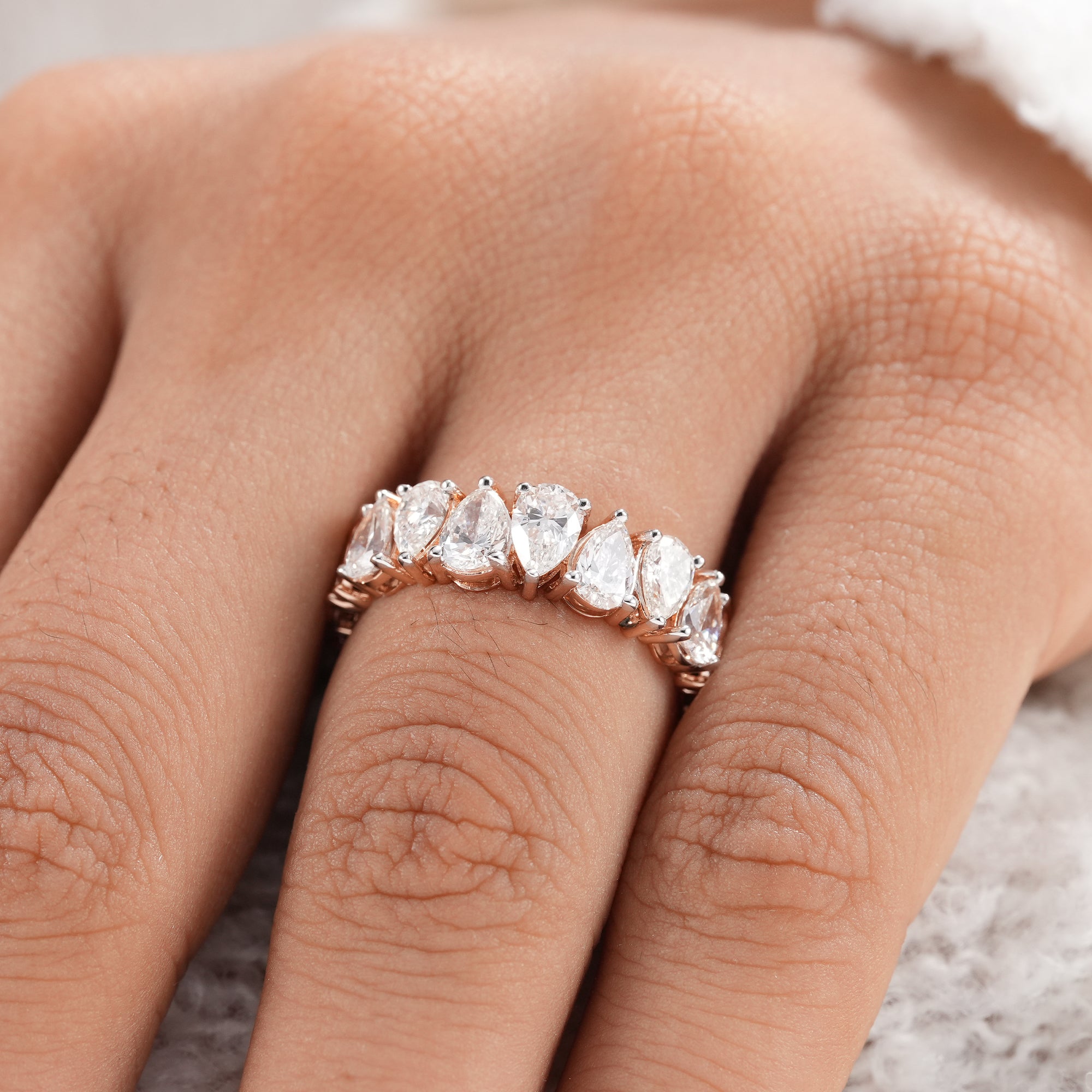 Fine jewelry pear diamond eternity band in rose gold.