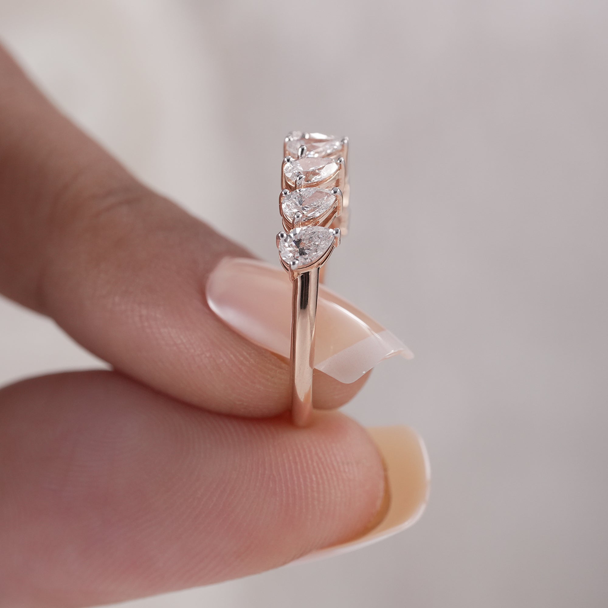 Delicate pear diamond anniversary band in rose gold