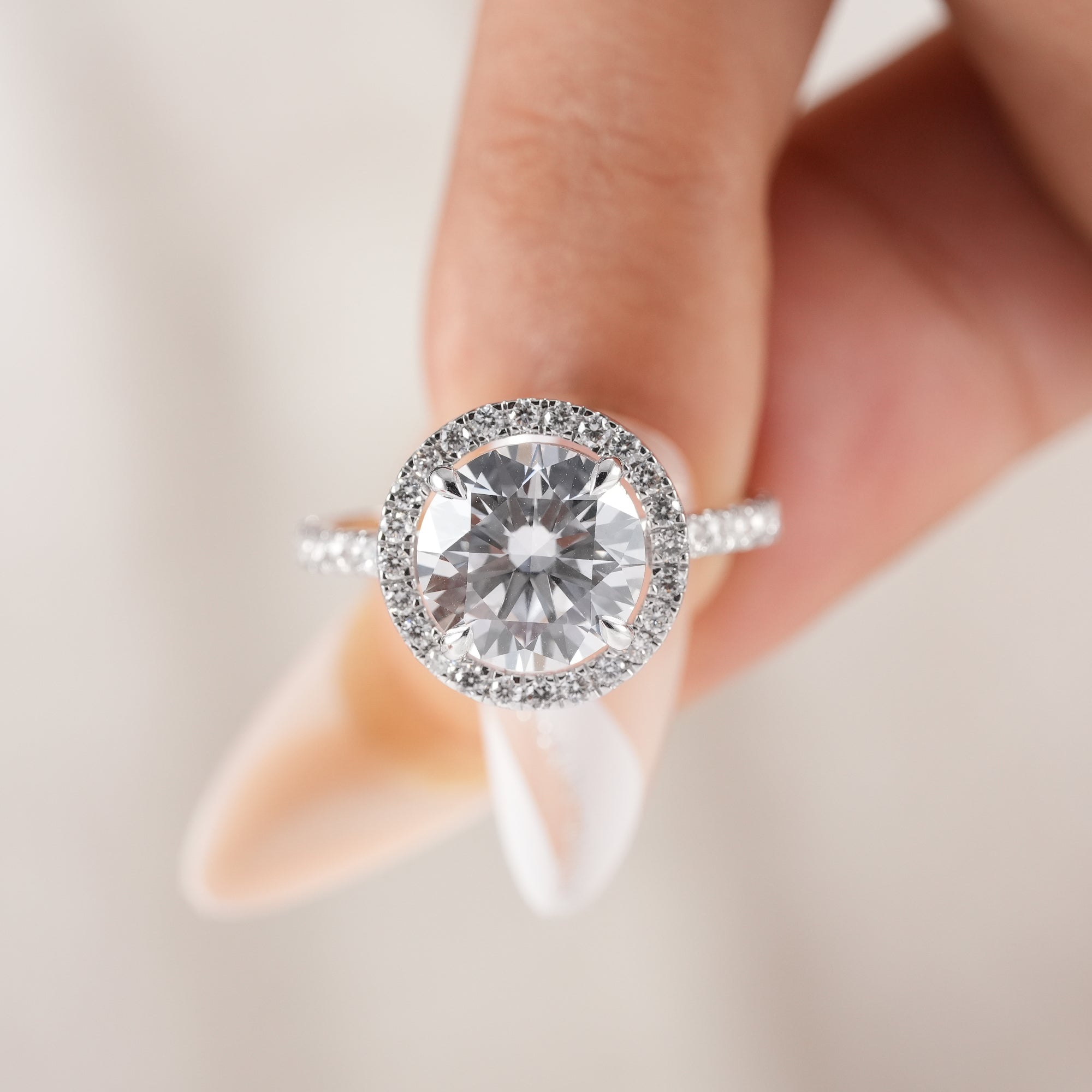 Round brilliant cut diamond ring with sparkling halo setting.