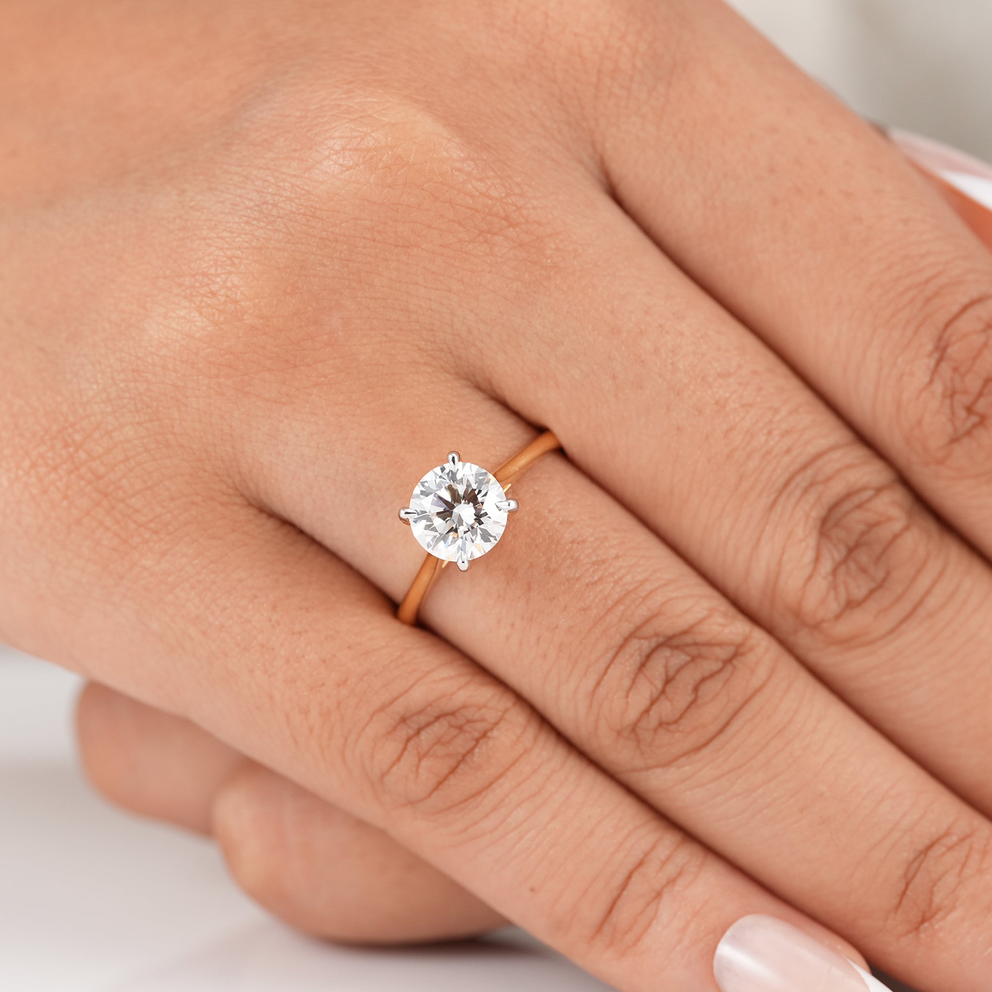 Minimalist round cathedral engagement ring with polished band