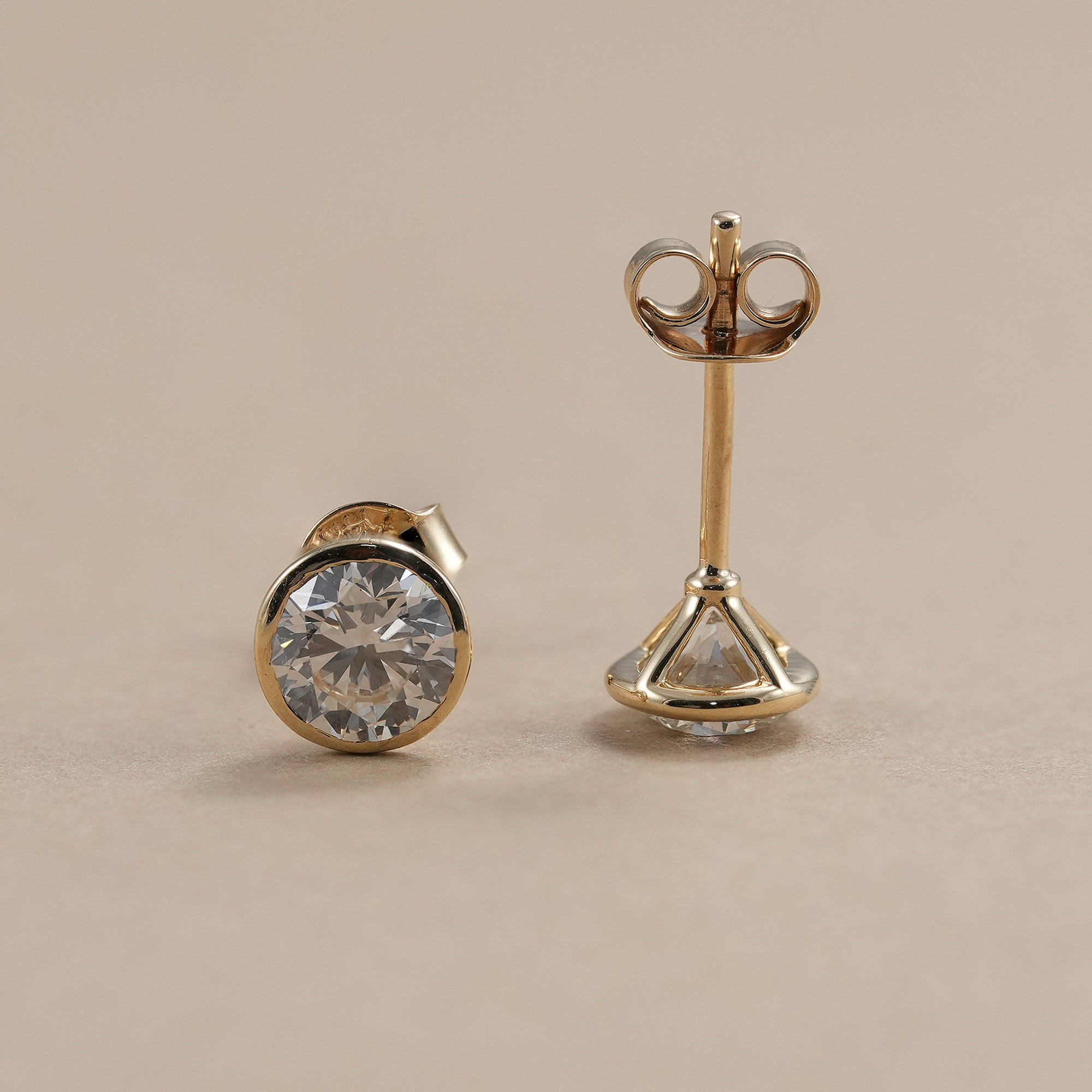 Classic lab grown diamond solitaire earrings with bezel setting.