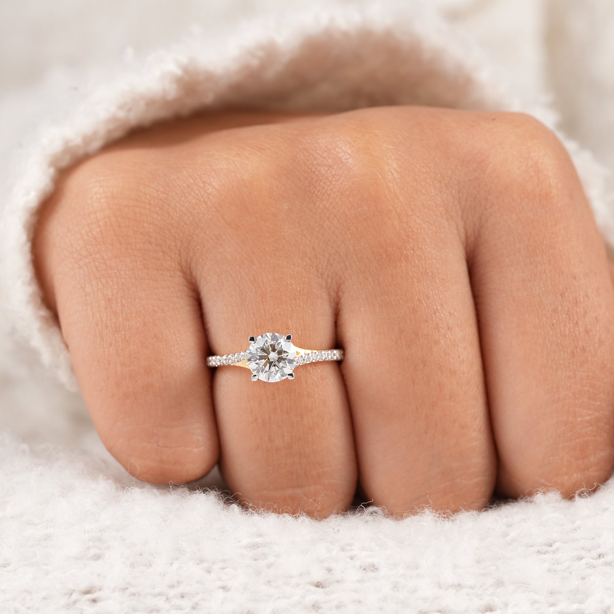 Minimalist round diamond ring with sparkling pavé band.
