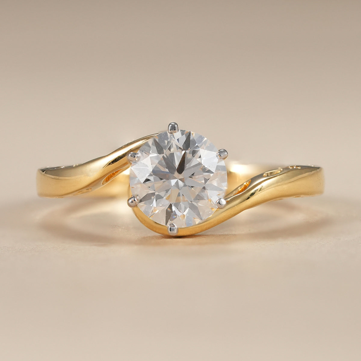Round lab grown diamond bypass engagement ring featuring a classic six prong solitaire setting in solid gold.