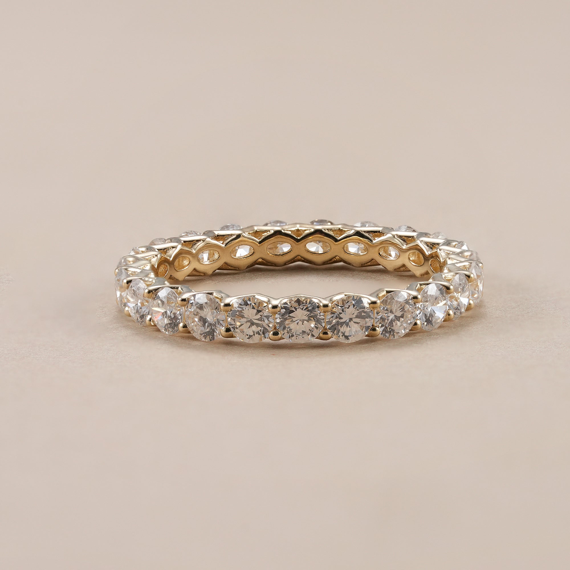 Round diamond eternity band with lab grown diamonds in yellow gold.