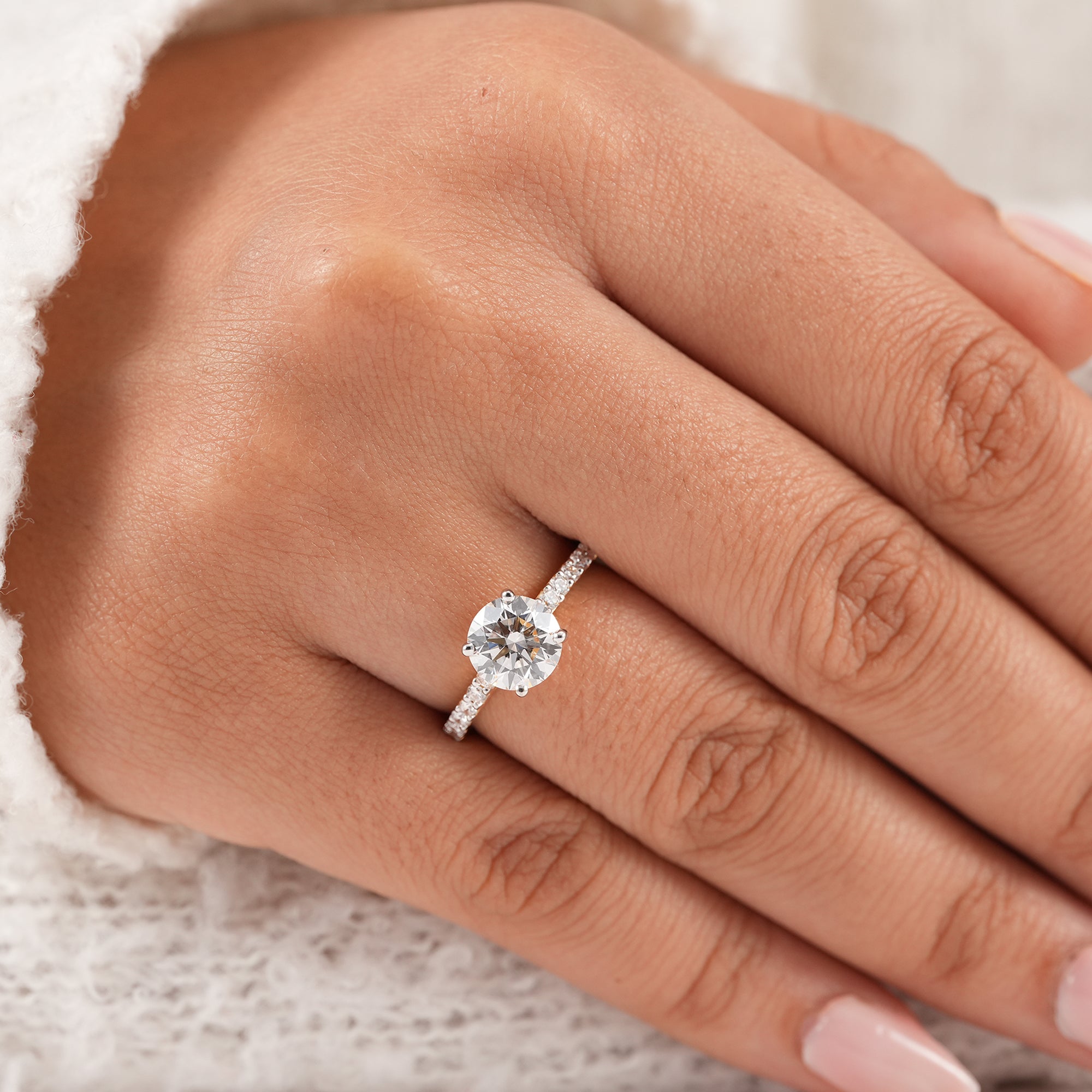 Round diamond engagement ring with sparkling pavé band