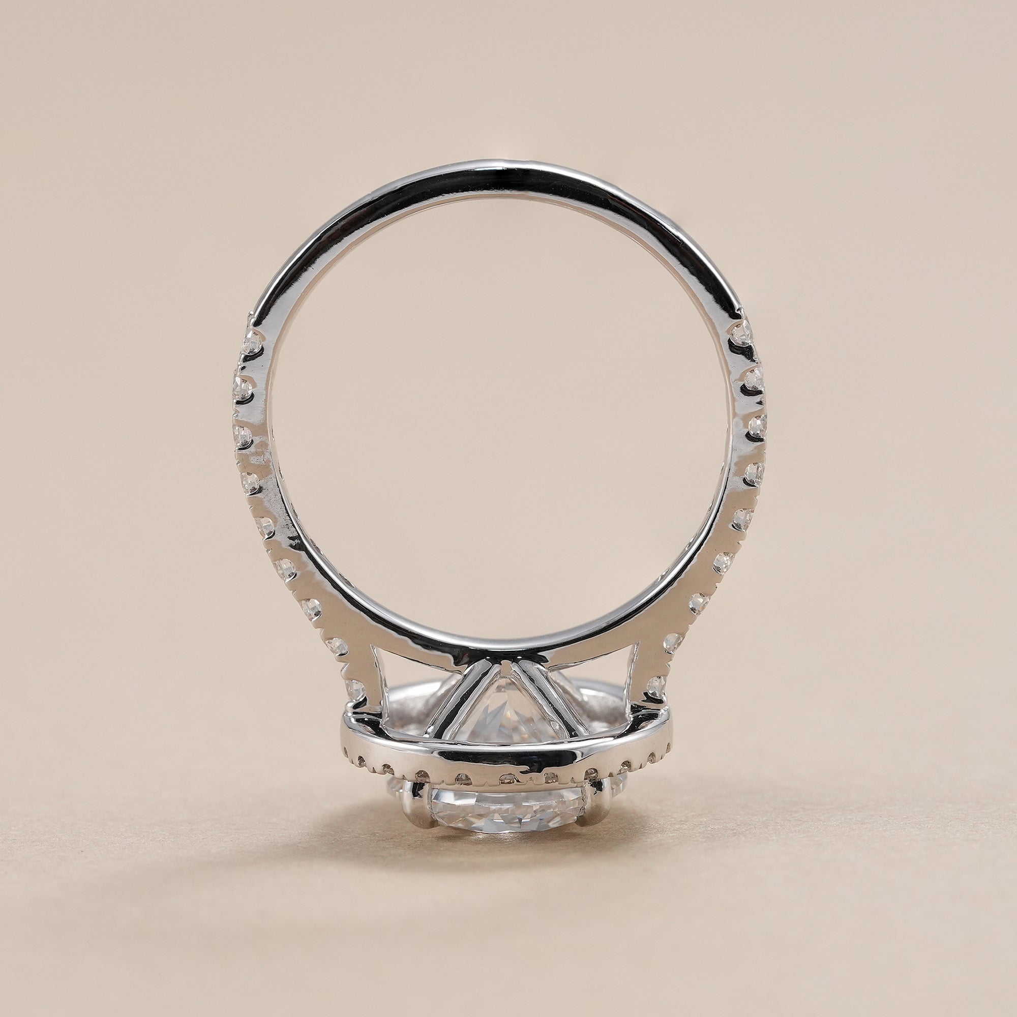 Halo engagement ring featuring a round brilliant center diamond.
