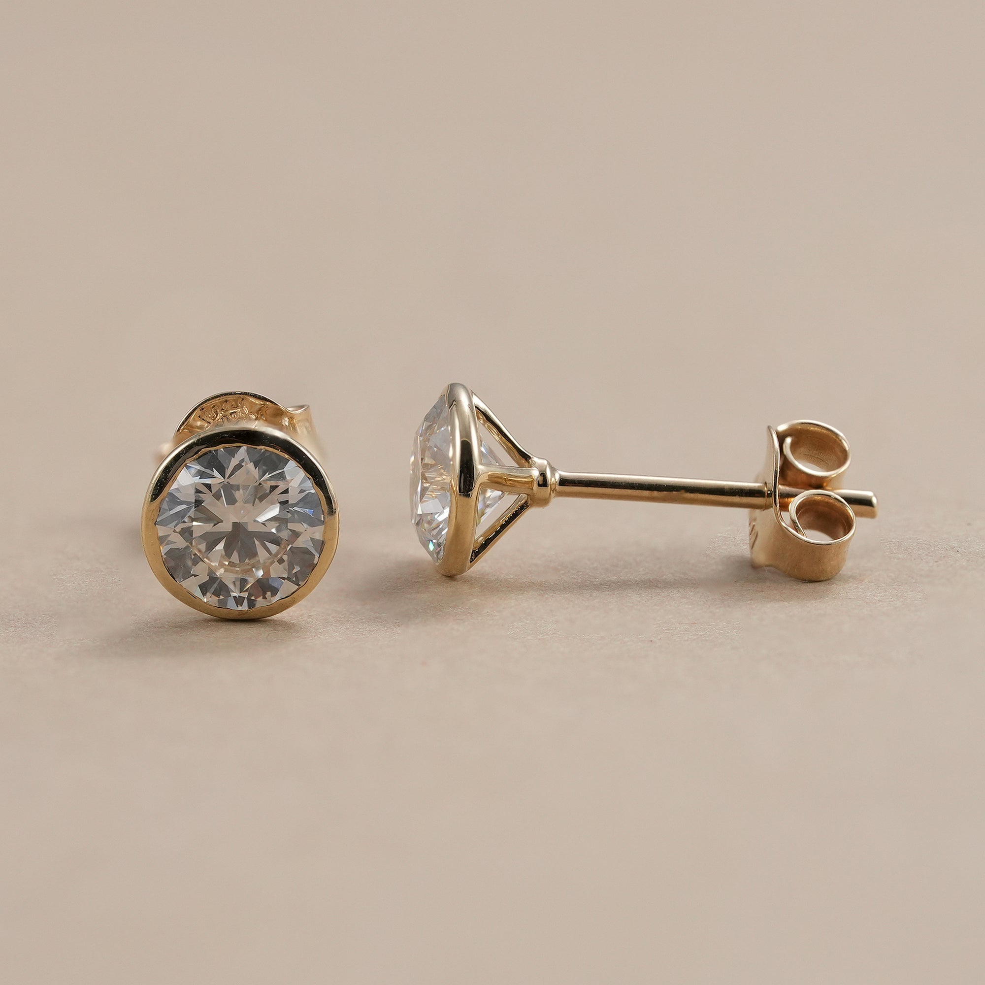 Elegant bezel set diamond earrings for women.