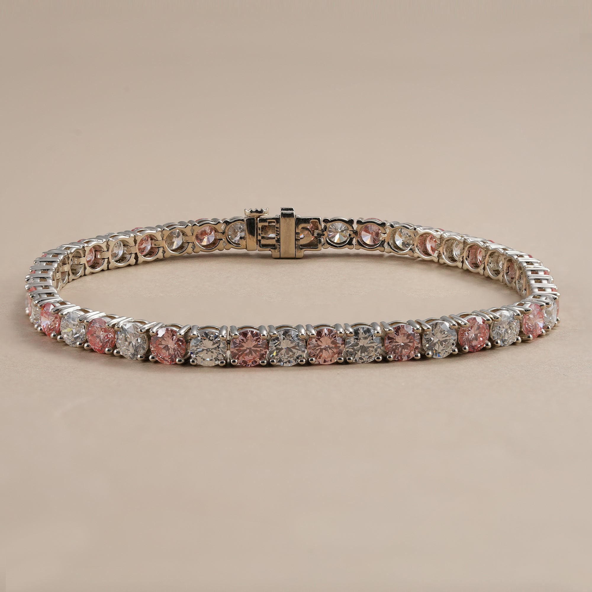 Round lab diamond tennis bracelet with alternating white and pink lab grown diamonds.