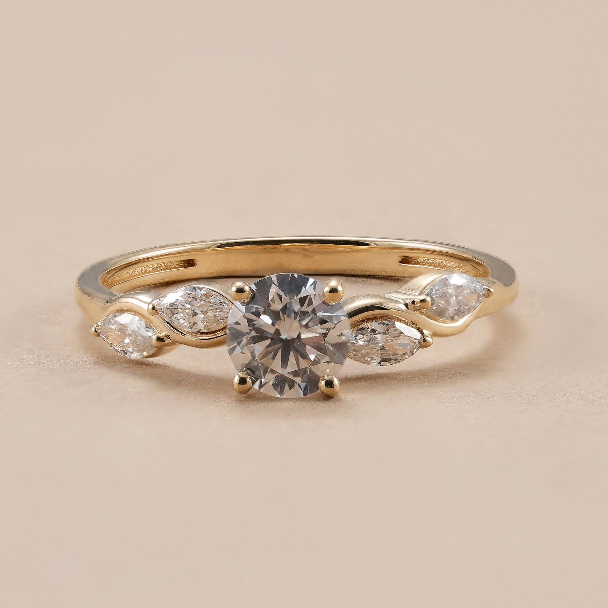 Round lab grown diamond engagement ring with elegant wave shank in yellow gold.