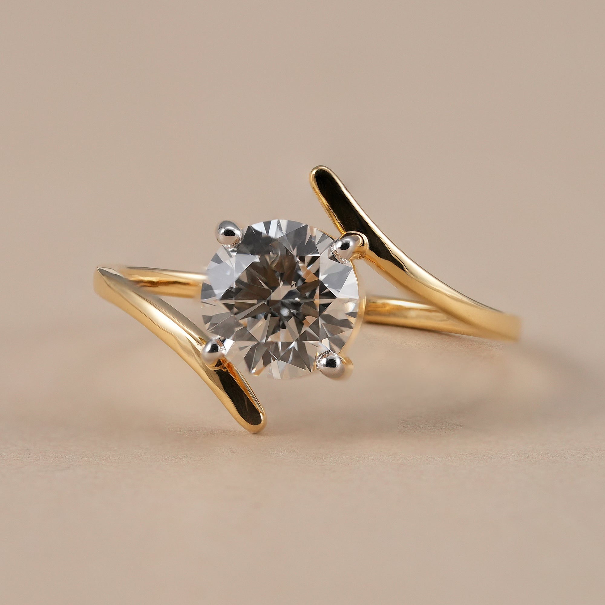 Round lab grown diamond bypass engagement ring in solid yellow gold