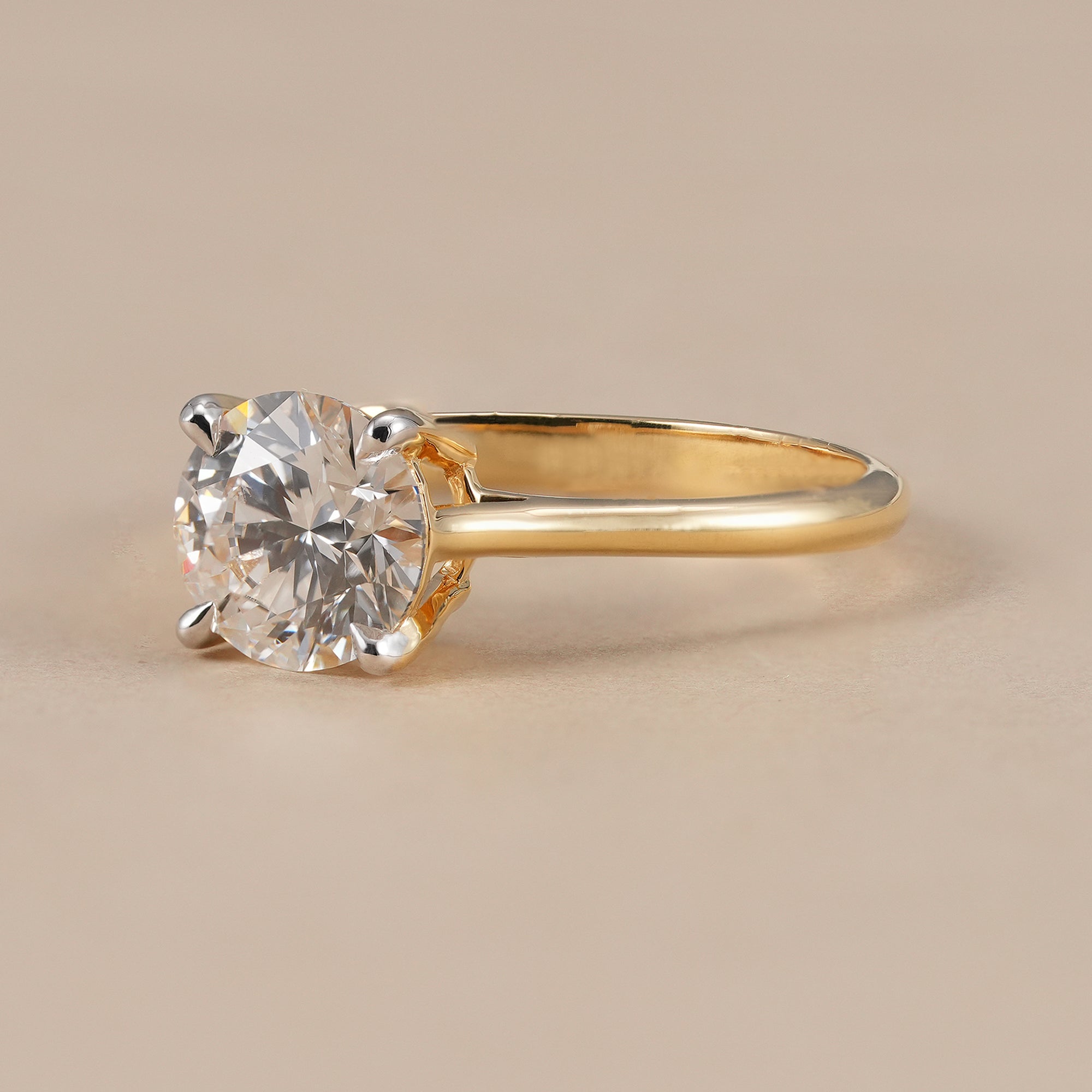 Classic round solitaire engagement ring with cathedral setting