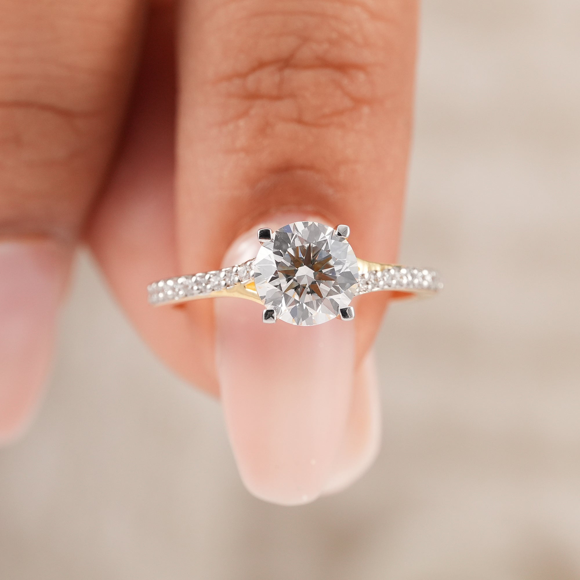 Round solitaire diamond ring in cathedral setting with pavé band