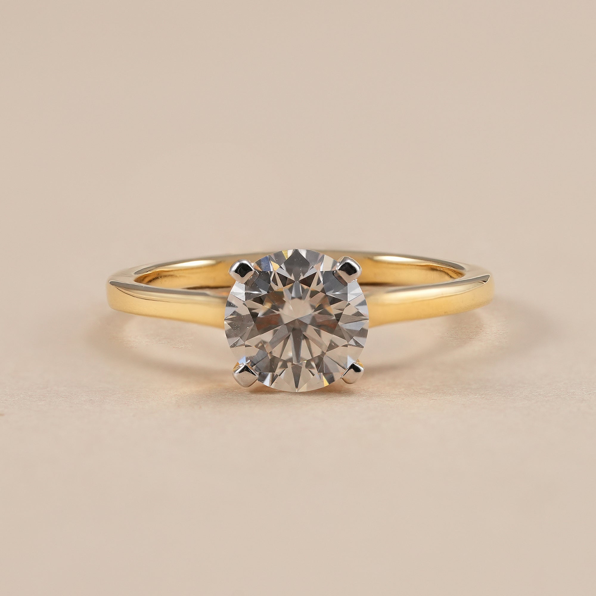 Round solitaire lab grown diamond engagement ring in classic four prong cathedral setting