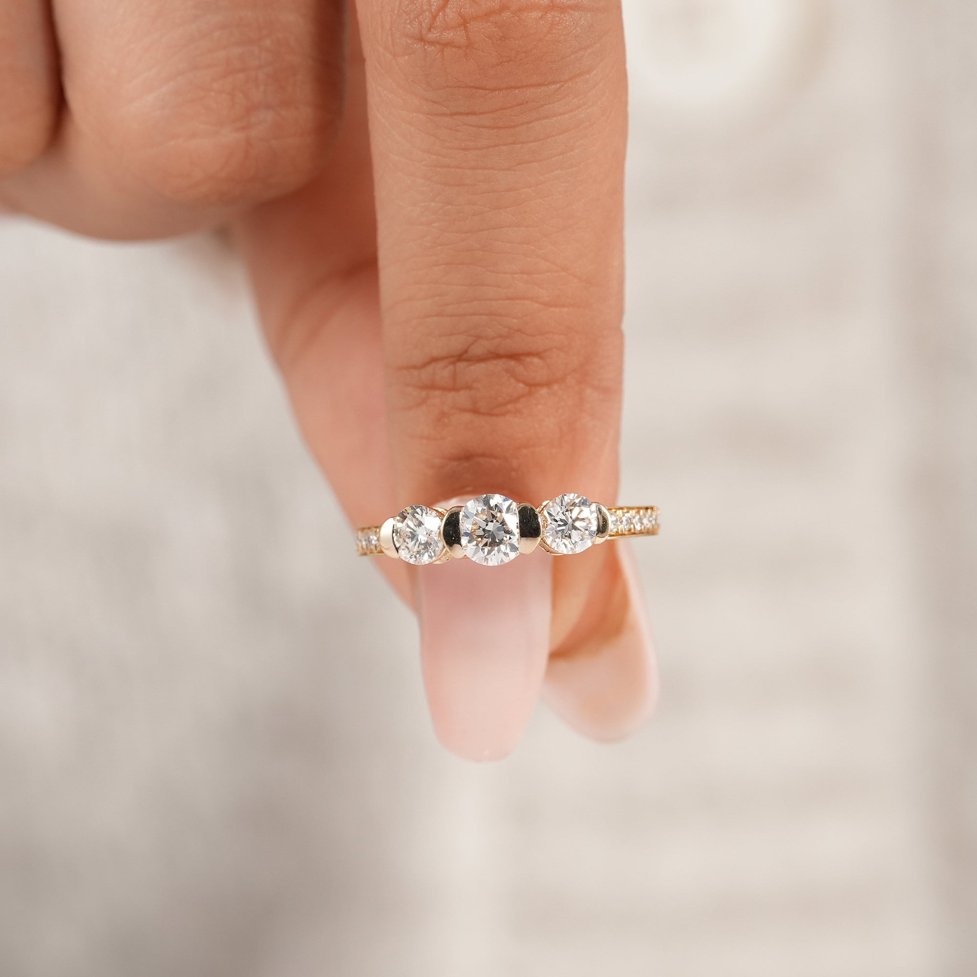 Trilogy lab diamond ring featuring three round brilliant diamonds in yellow gold