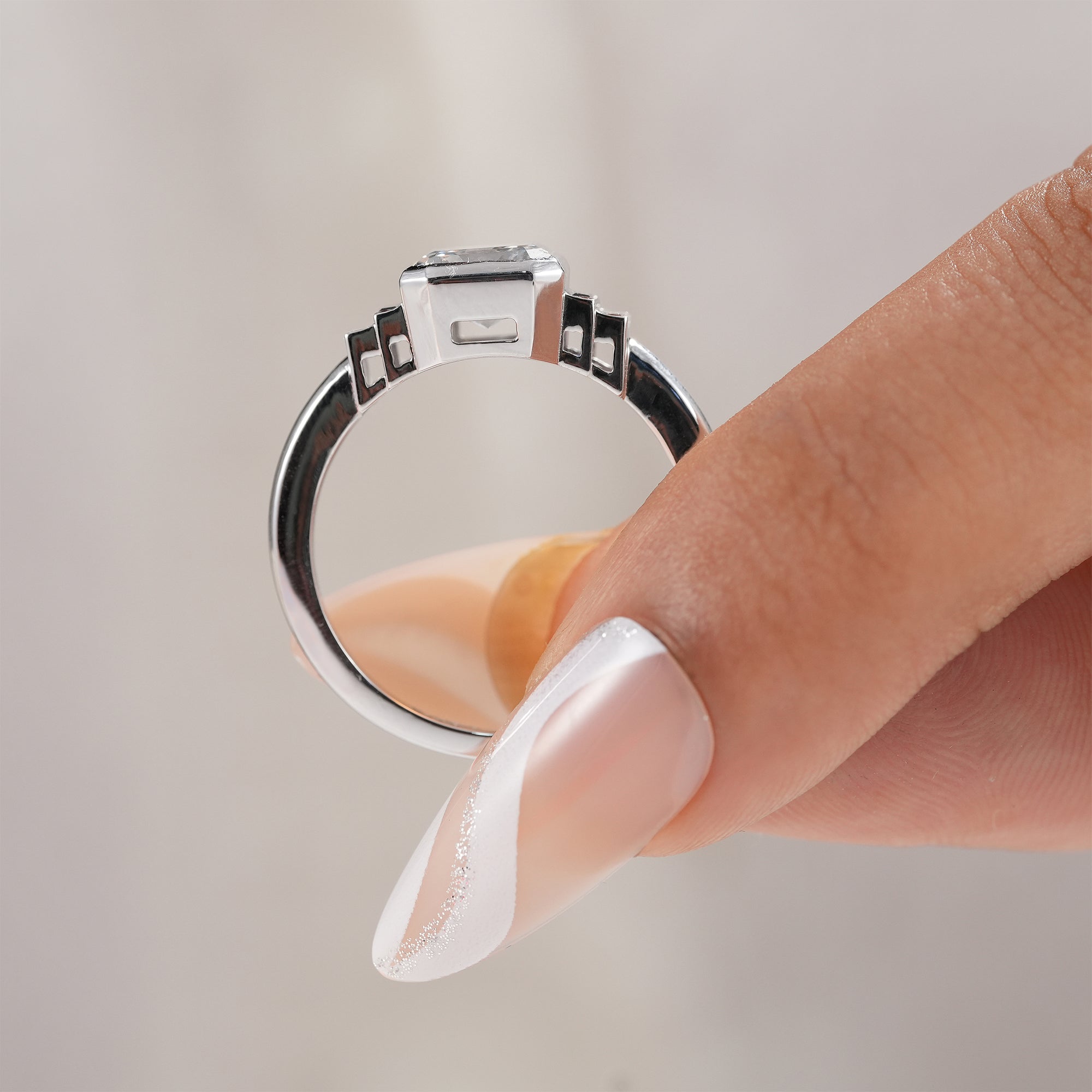 Modern bridal ring featuring Asscher lab diamond and sapphire accents.
