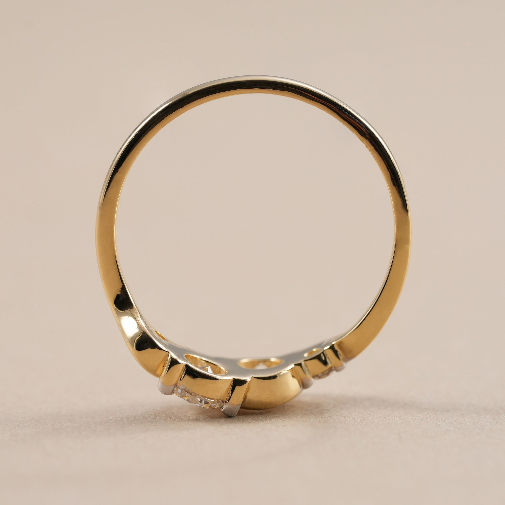 Minimalist stackable diamond ring with elegant wave design.