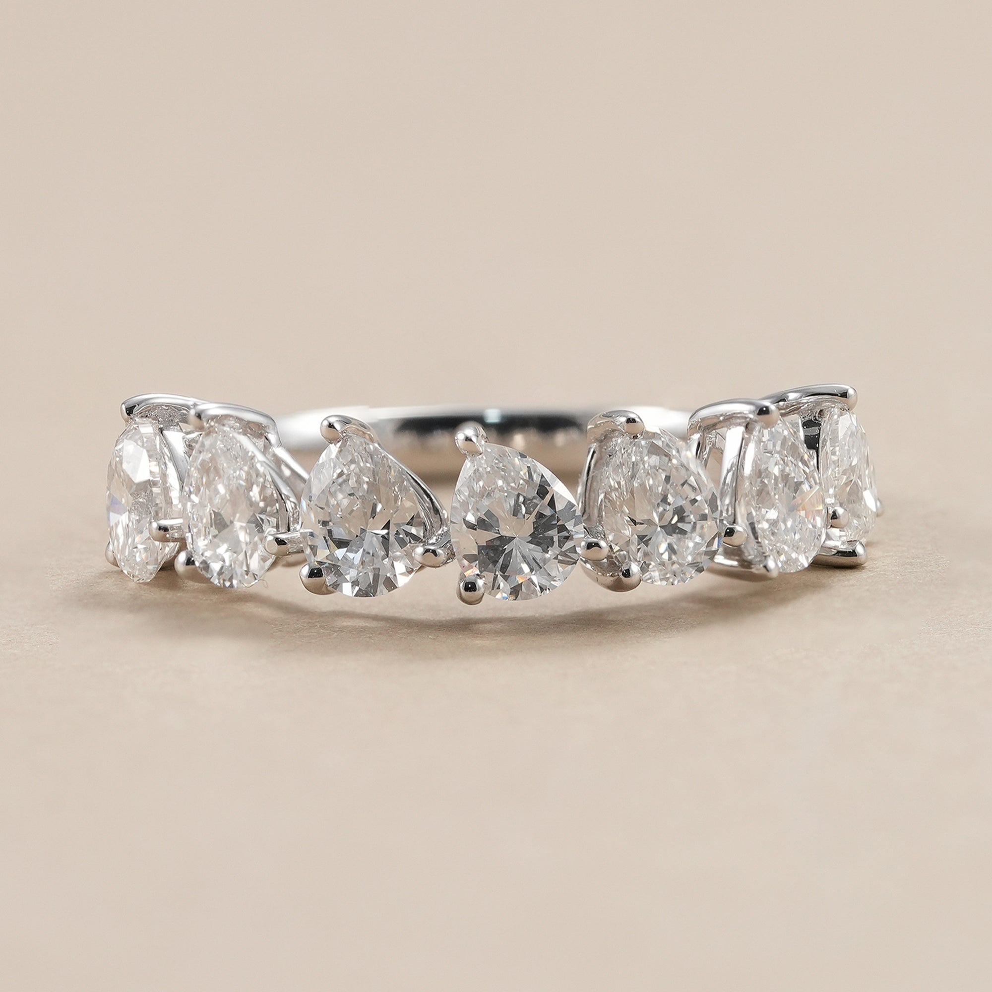 Seven stone pear lab diamond wedding band in polished white gold.