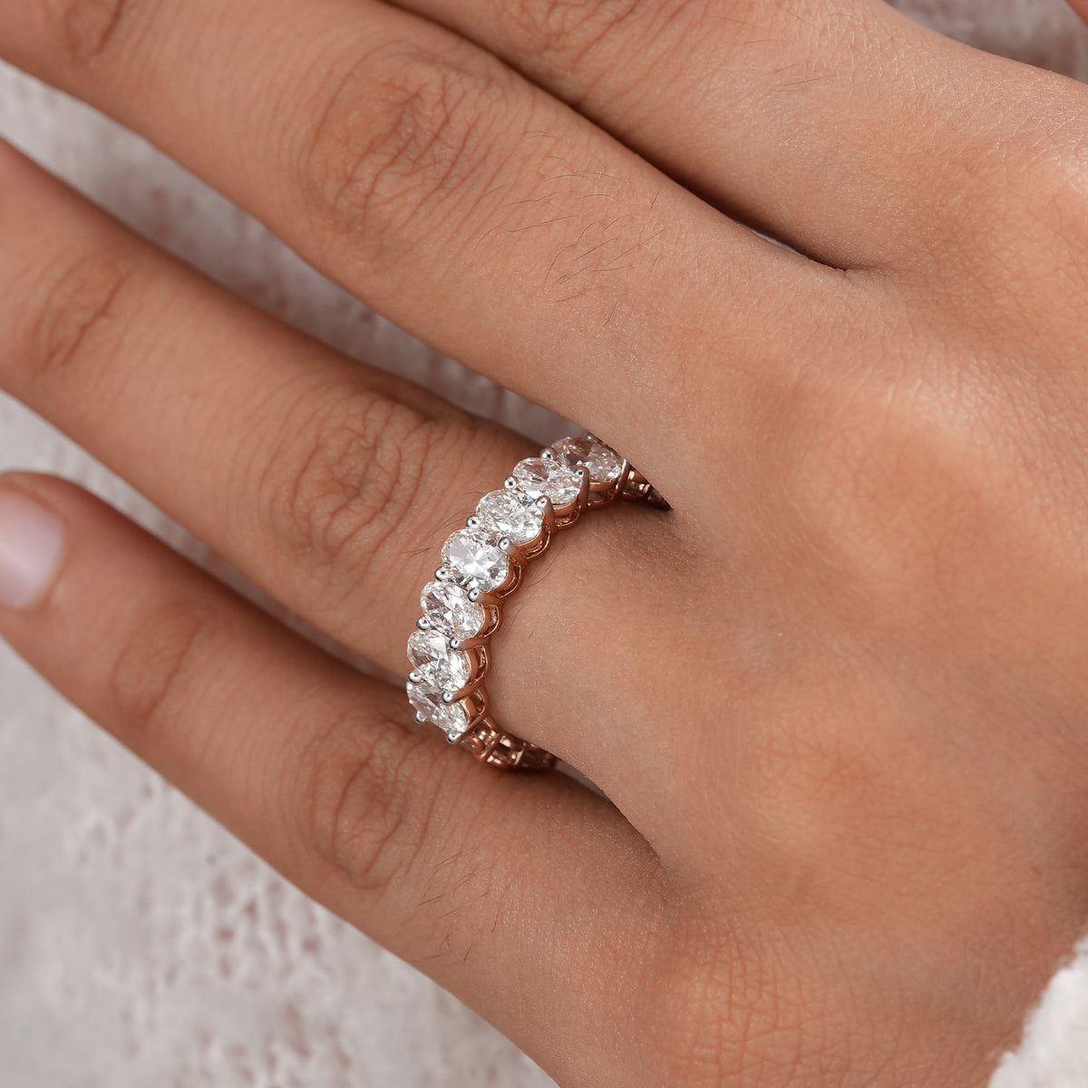 Rose gold oval diamond eternity band for bridal jewelry.