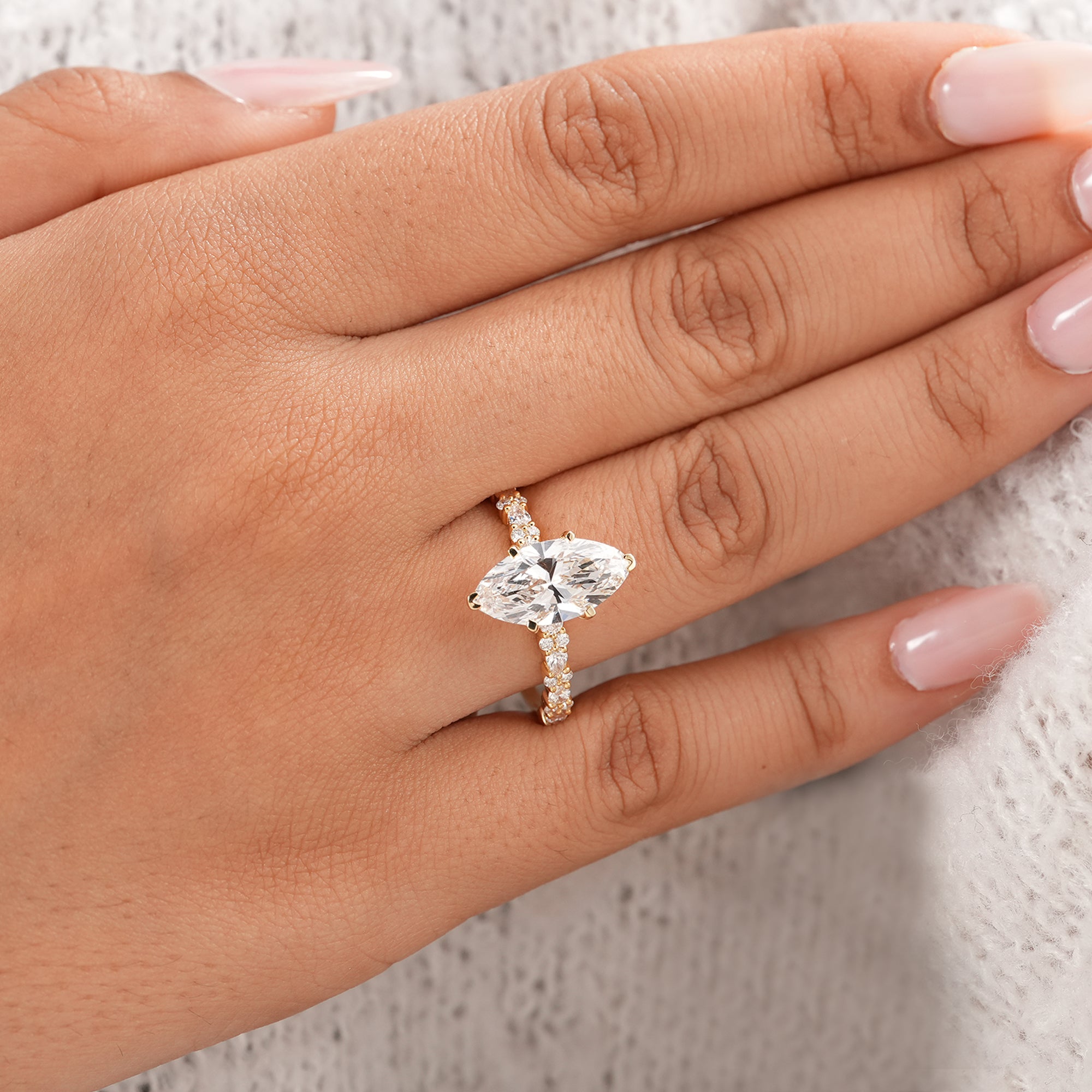 Marquise solitaire ring with sparkling accent diamond band