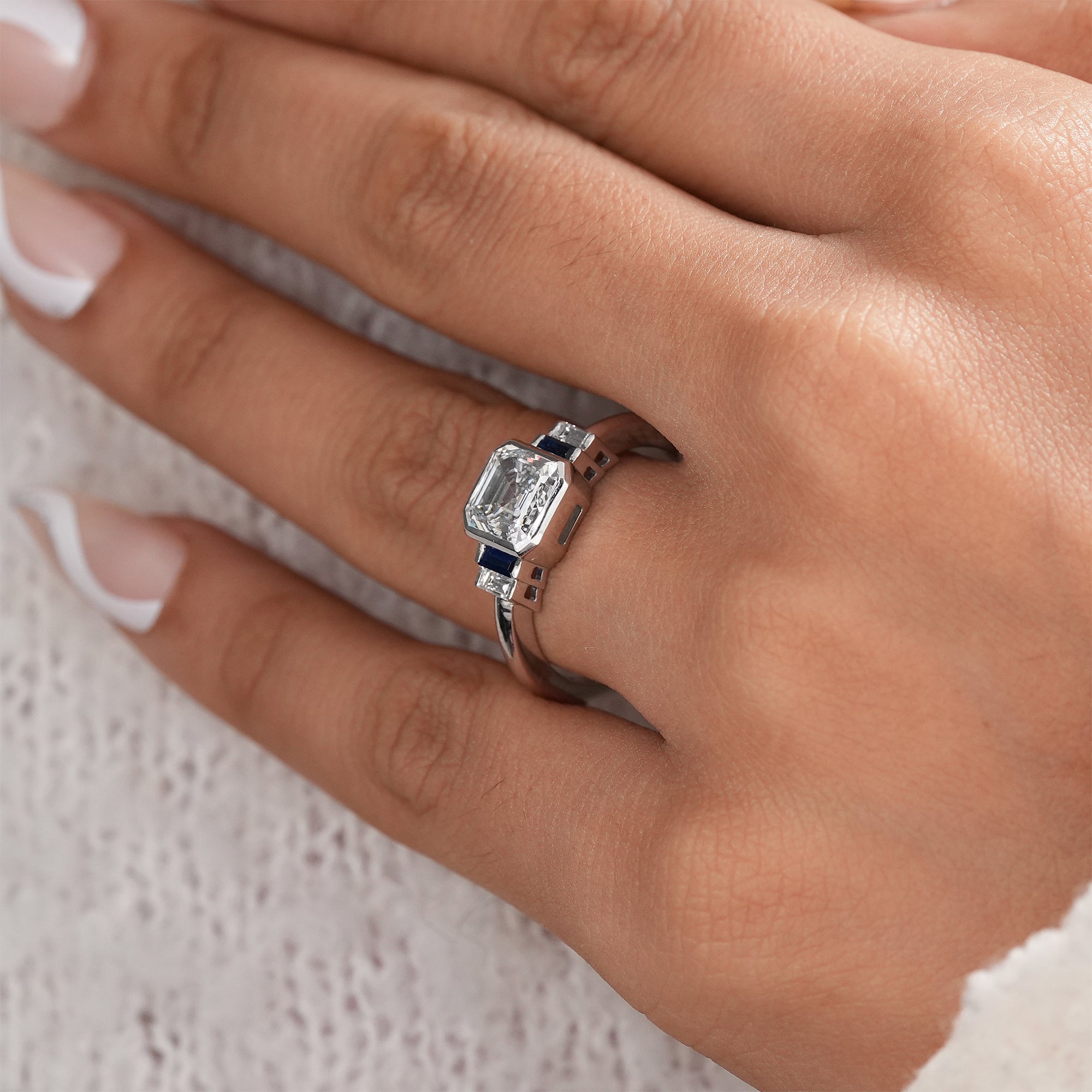 Luxury lab grown diamond engagement ring with sapphire details.