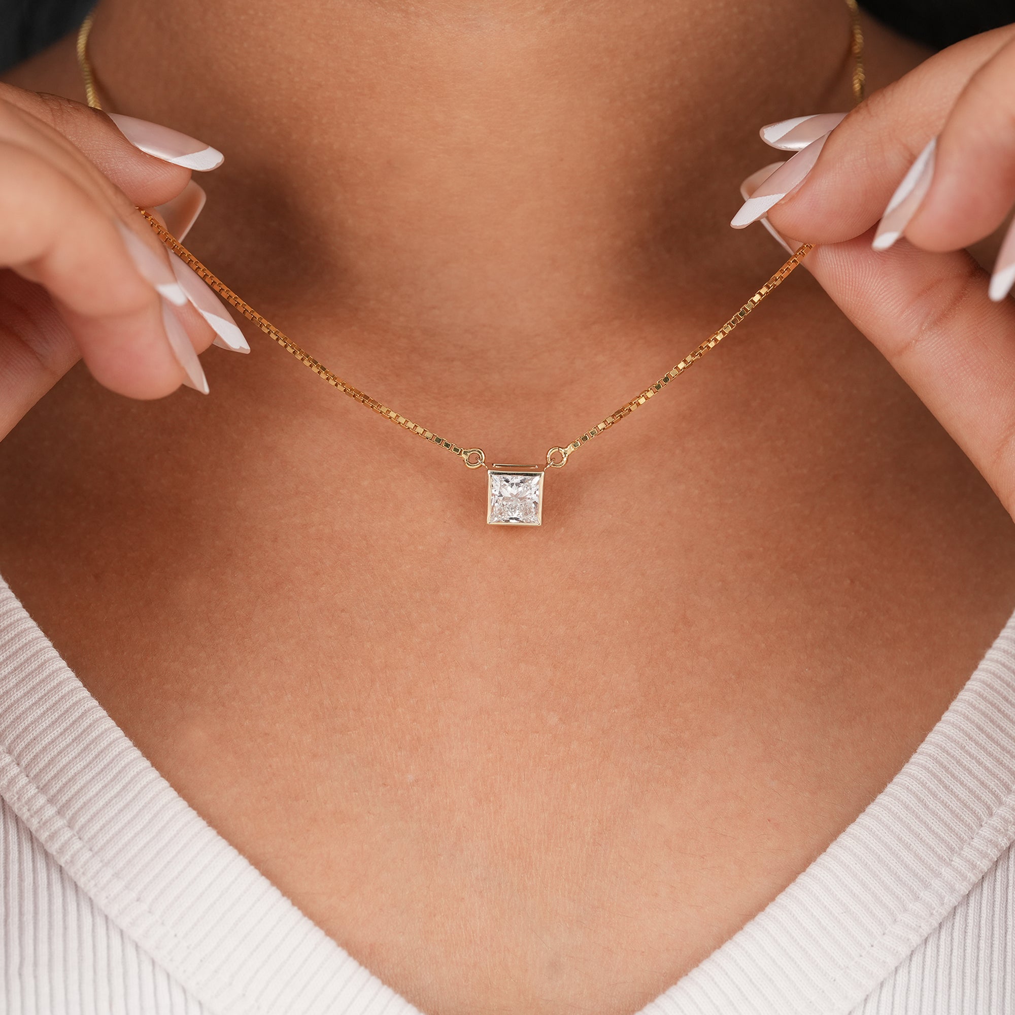 Bezel set princess cut diamond pendant on gold chain
