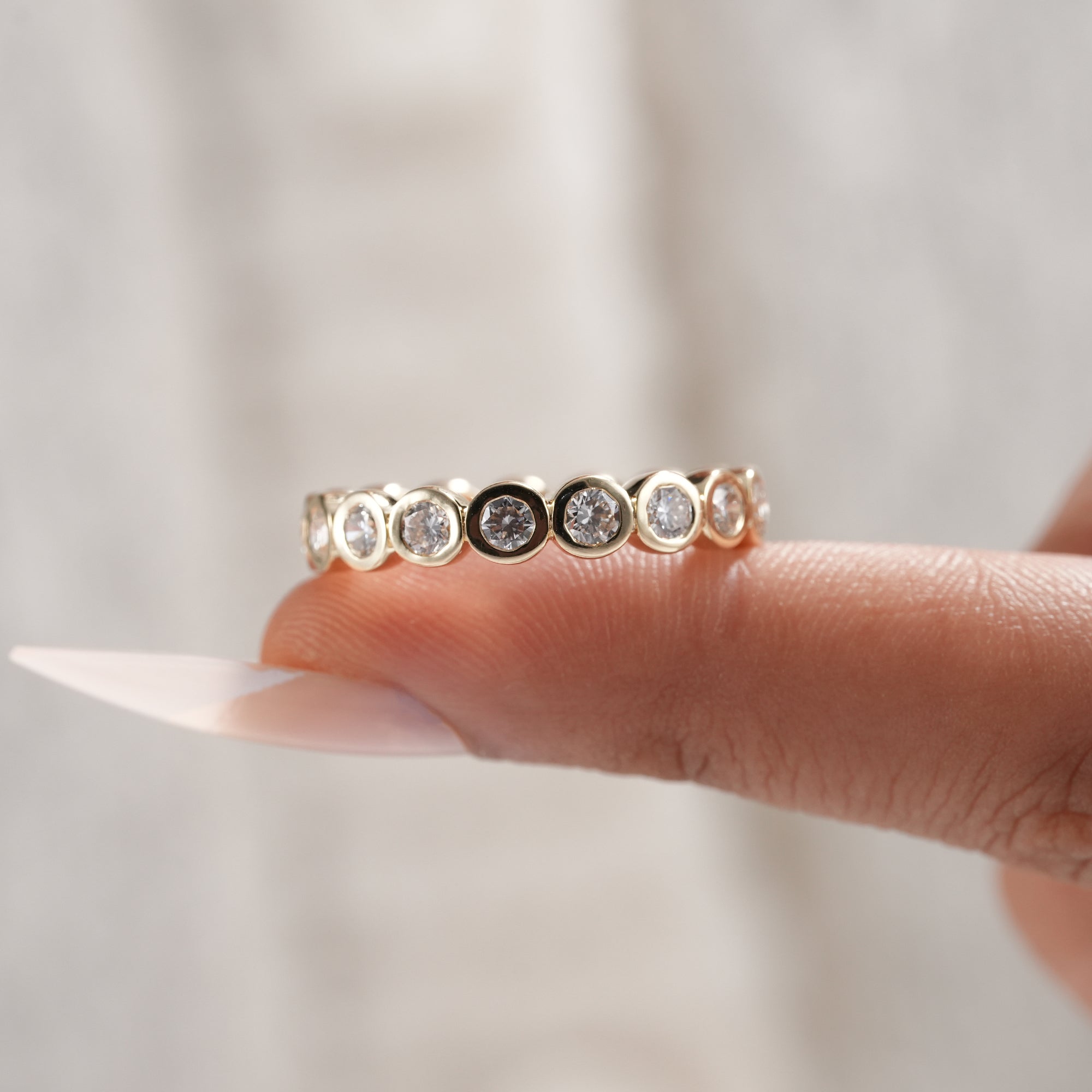 Luxury bezel set diamond wedding band handcrafted in gold.