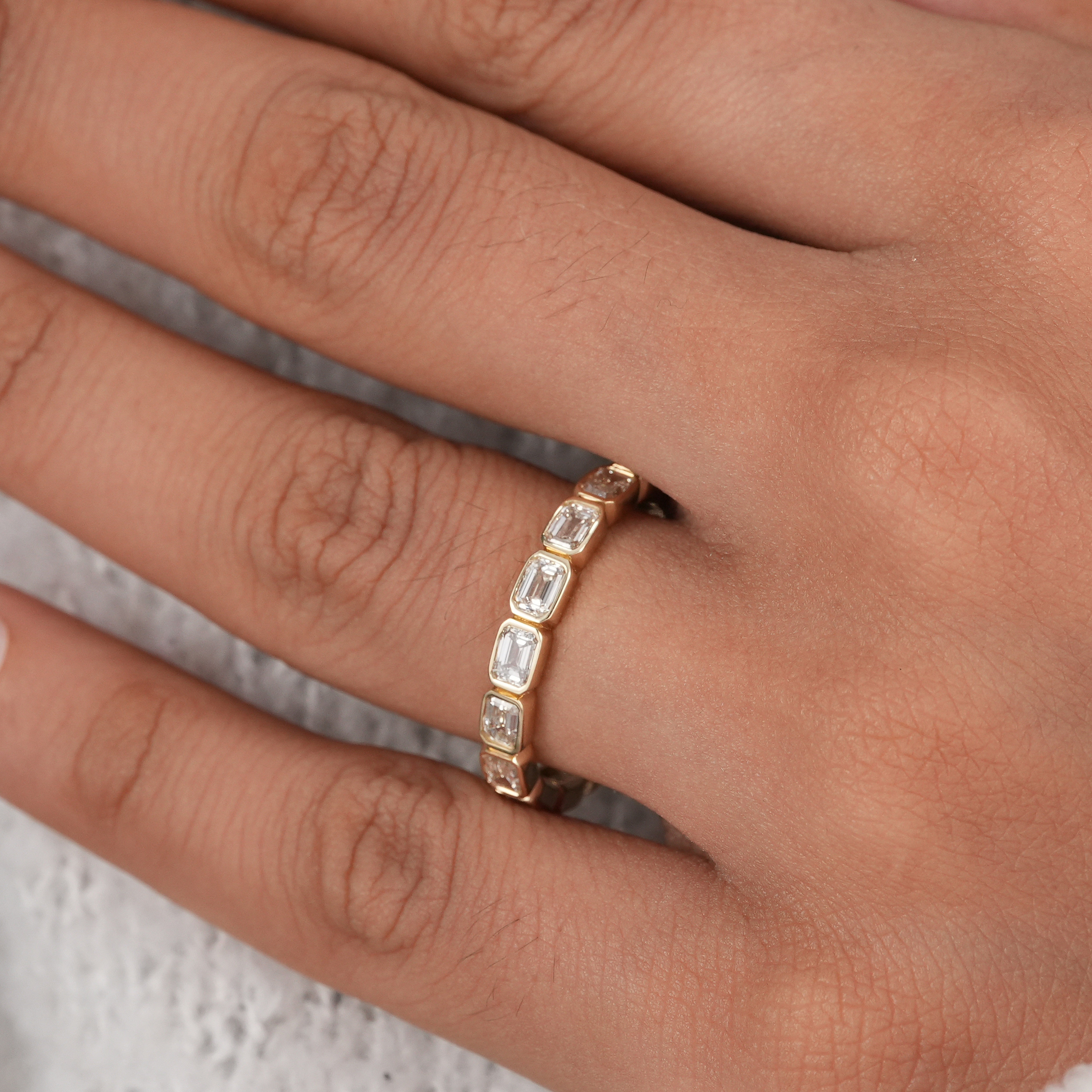 Modern bridal jewelry emerald cut eternity ring.