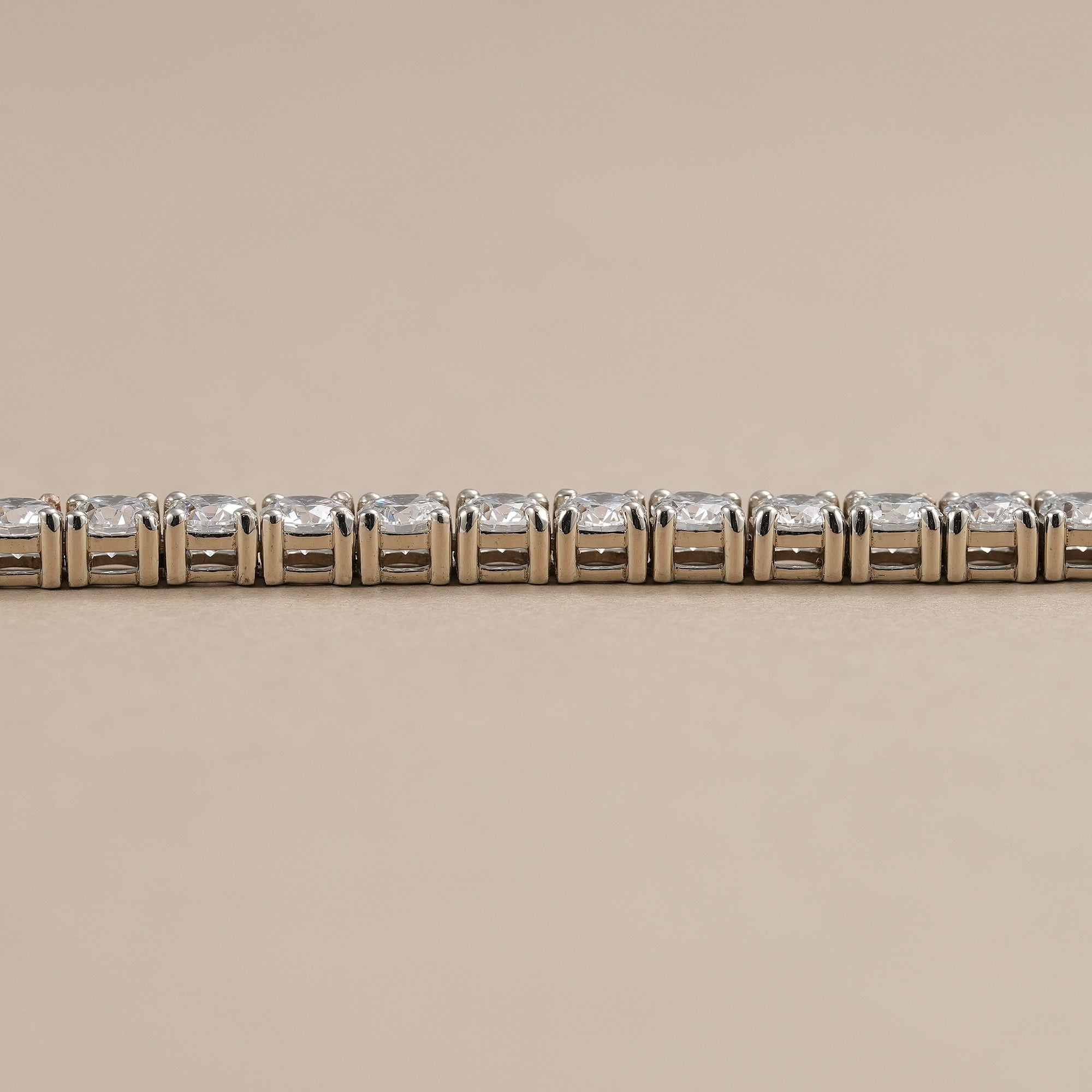 Stackable lab diamond bracelet with classic four-prong setting.