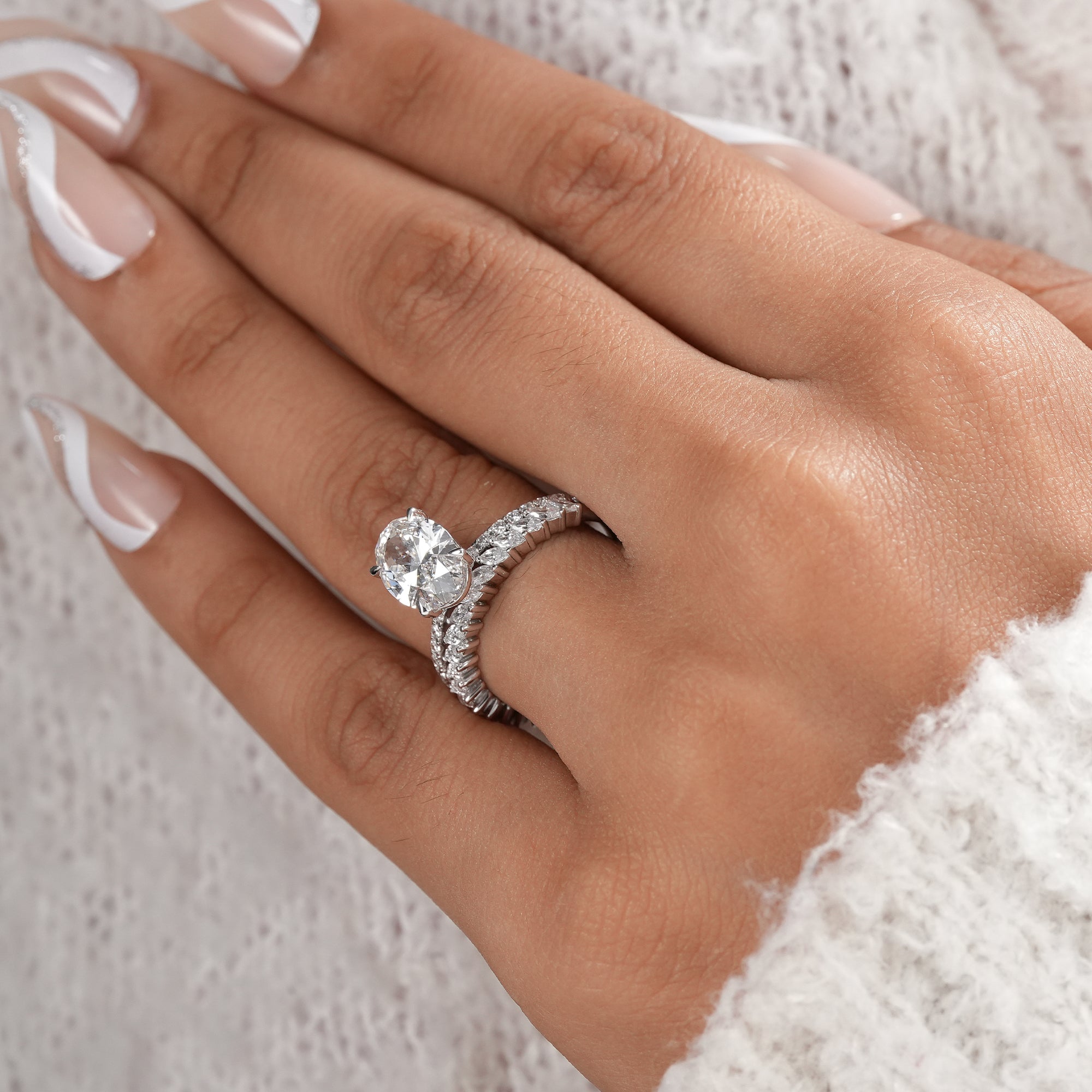 Elegant 2 CT oval diamond engagement ring with matching wedding band.