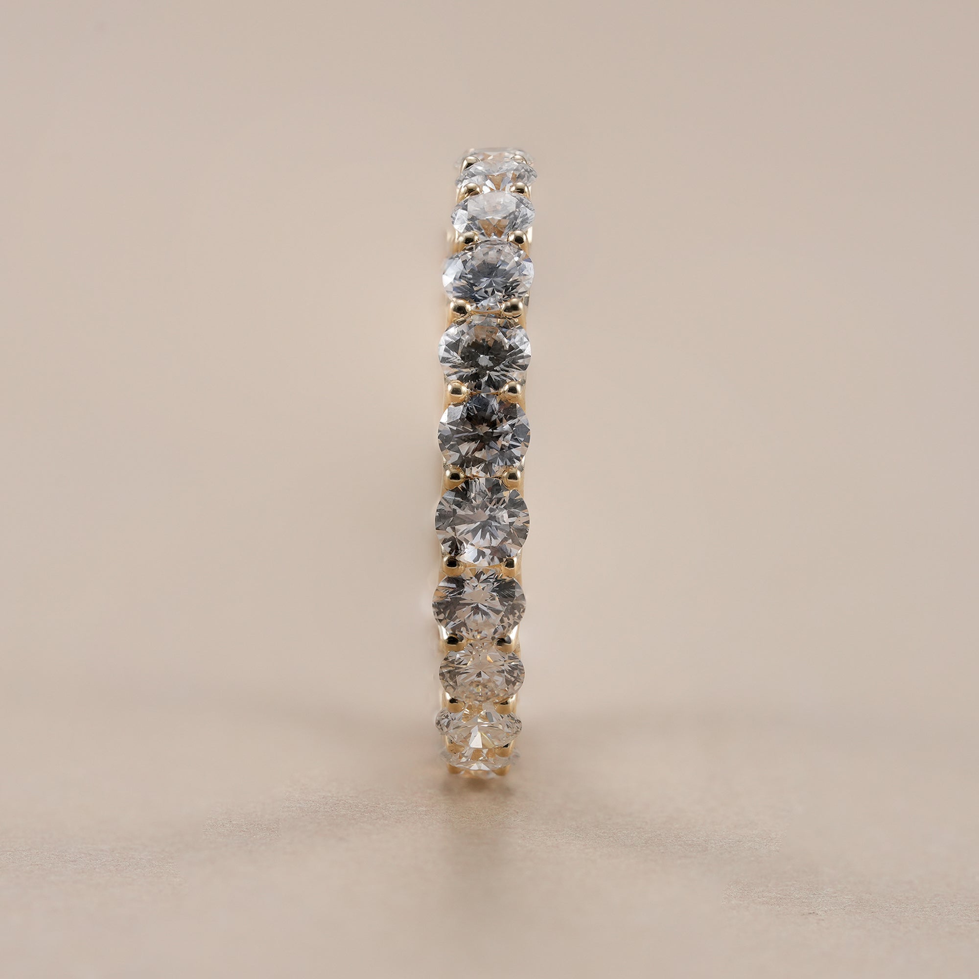 2.9mm round diamond wedding band handcrafted in gold.