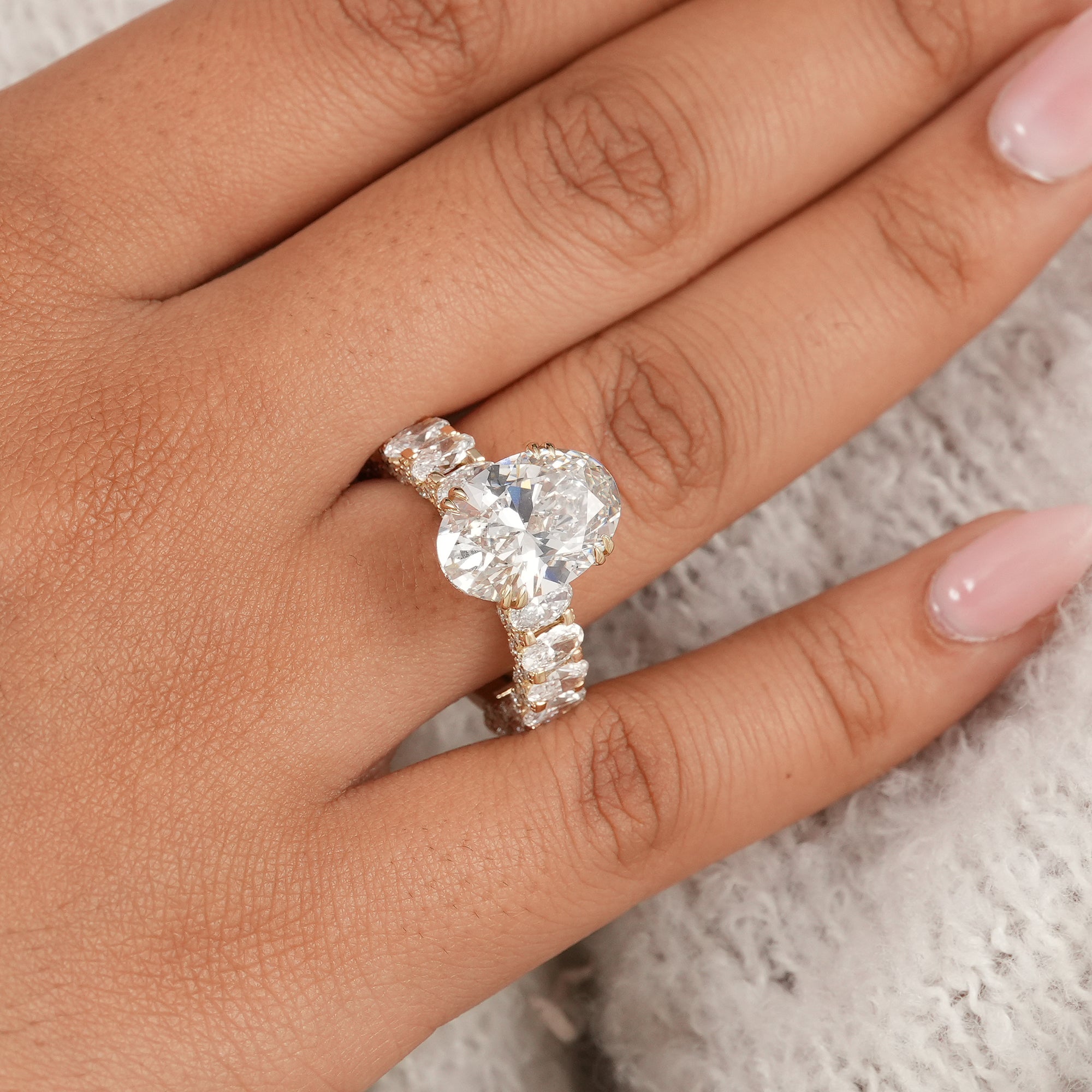 Elegant anniversary ring featuring a large oval lab diamond with detailed diamond band.