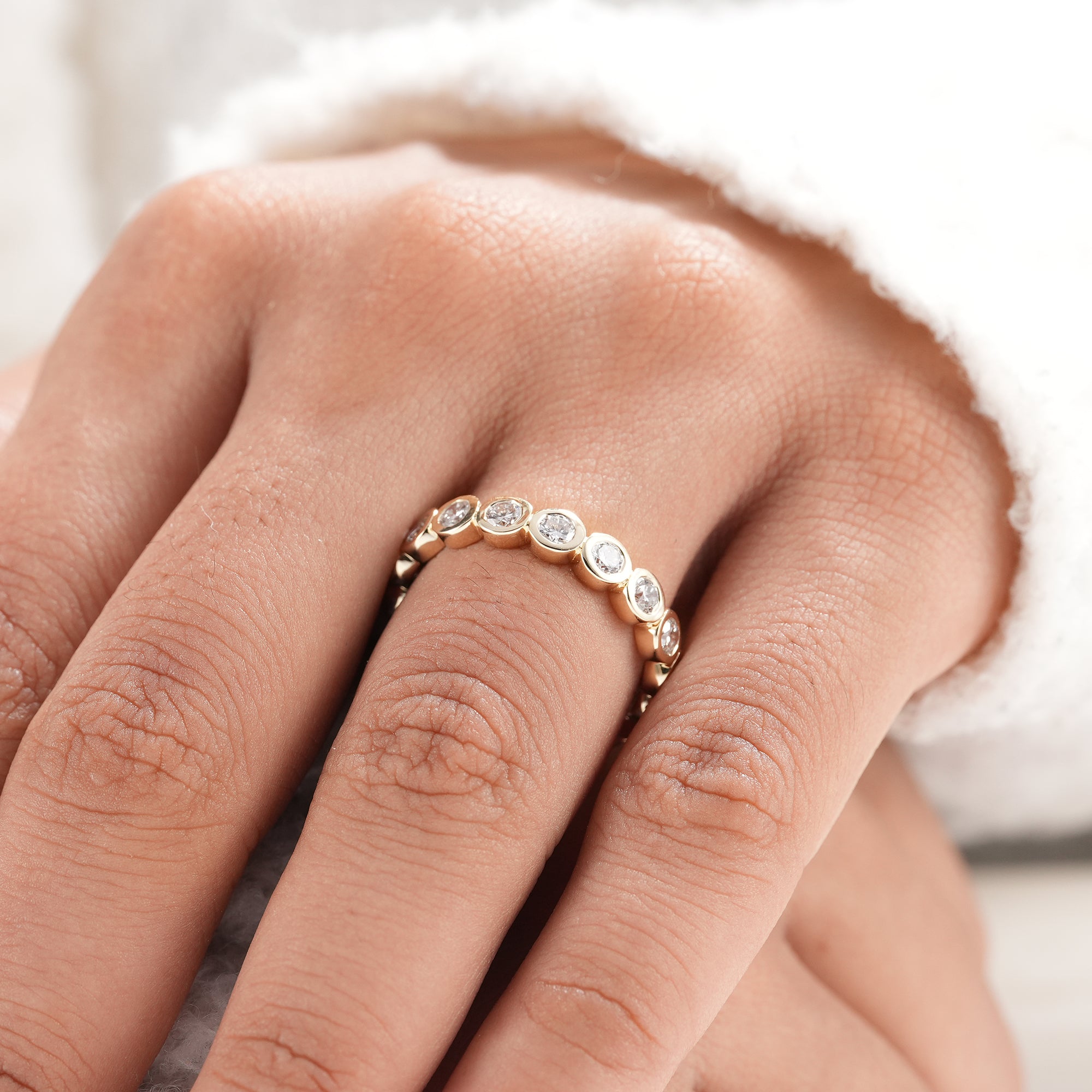 Yellow gold bezel set diamond stacking ring.
