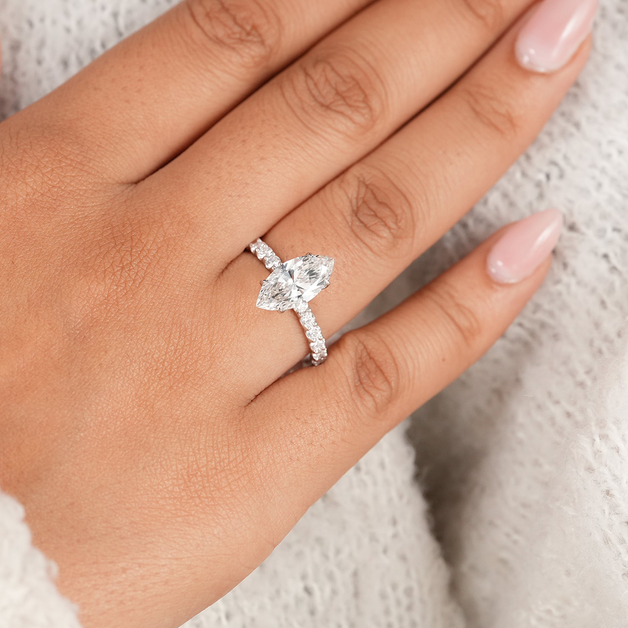 Marquise wedding ring with brilliant round accent diamonds