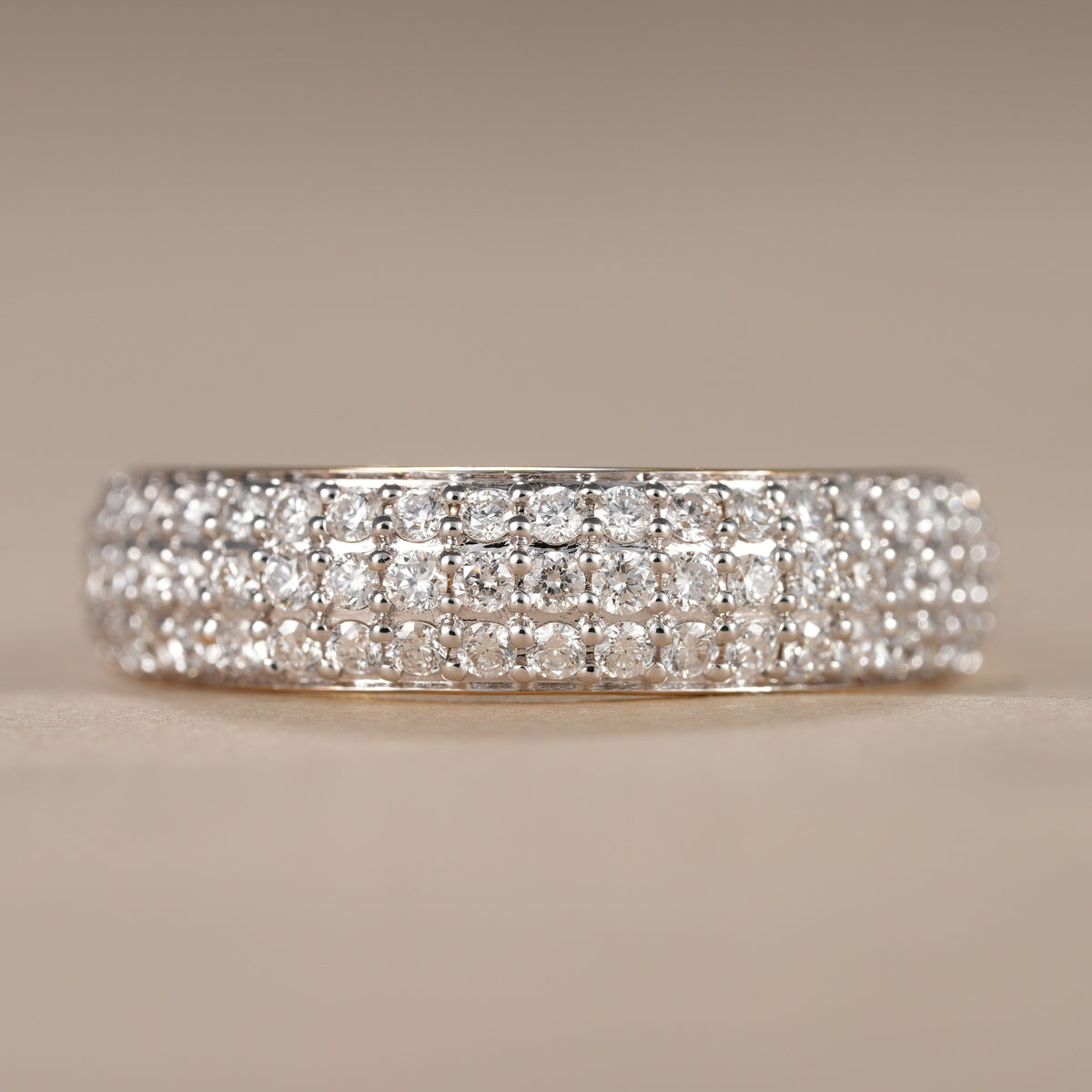 Triple row pave lab diamond wedding band crafted in solid gold with brilliant round diamonds.