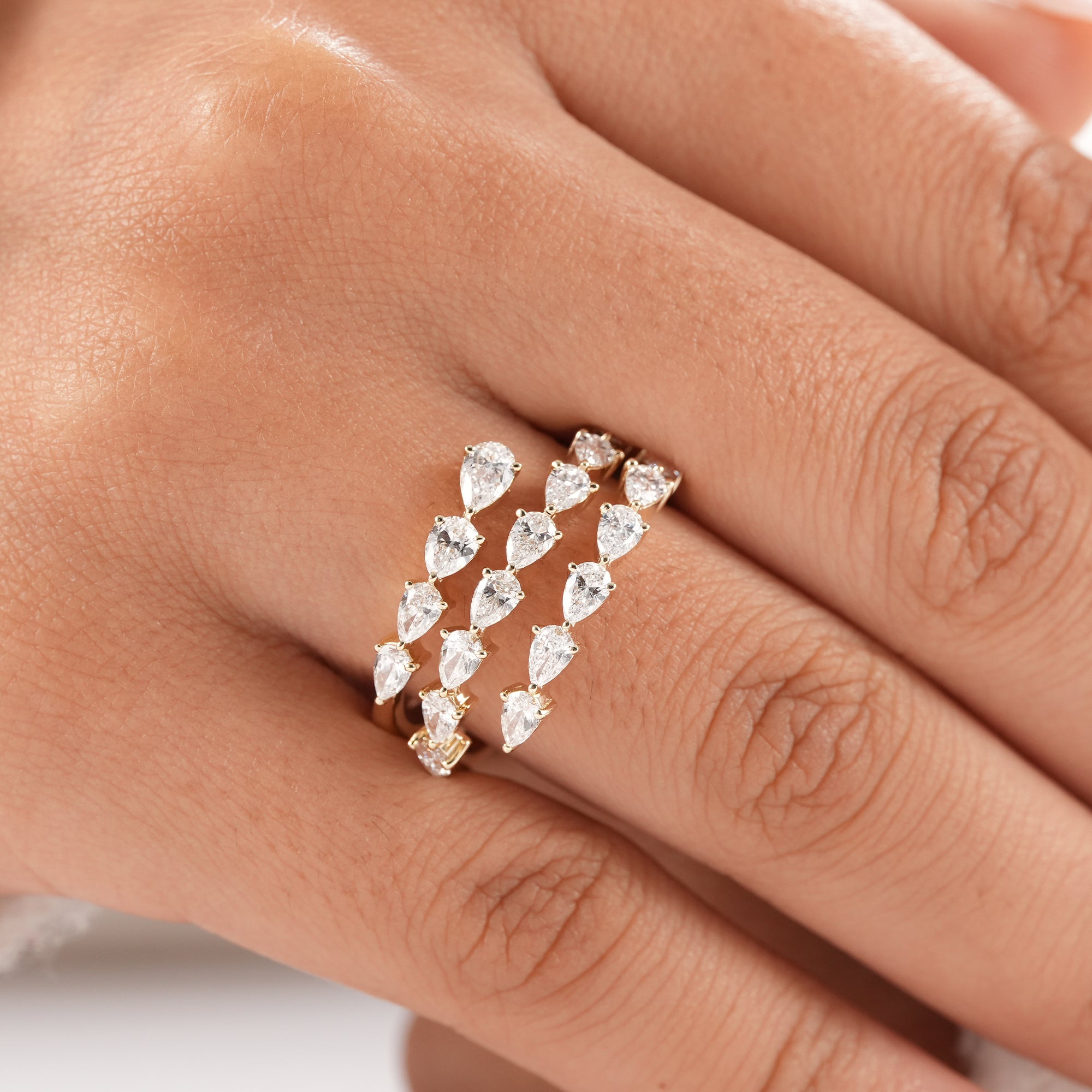 Bridal jewelry featuring three rows of pear lab diamond.