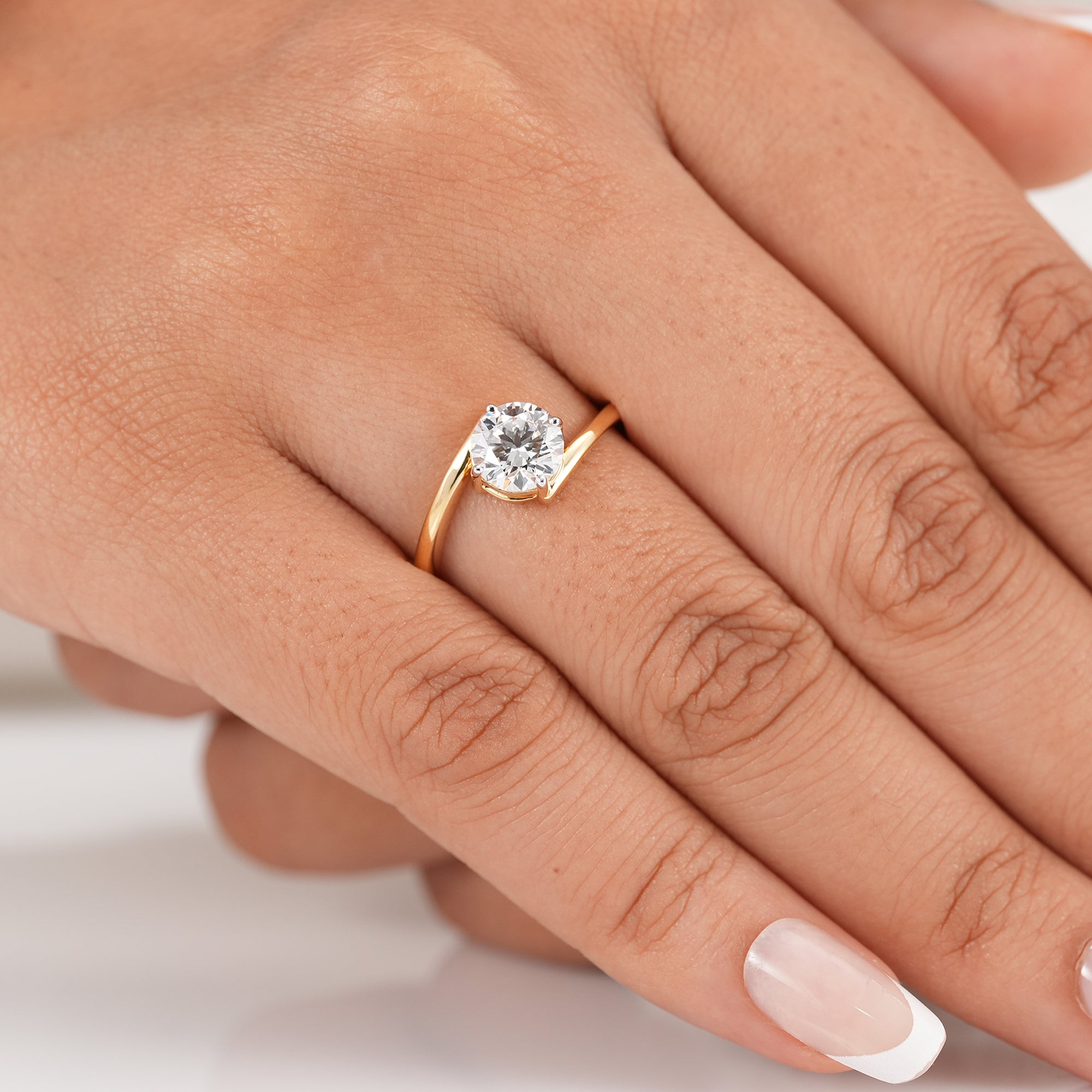 Modern open bypass diamond engagement ring with round solitaire