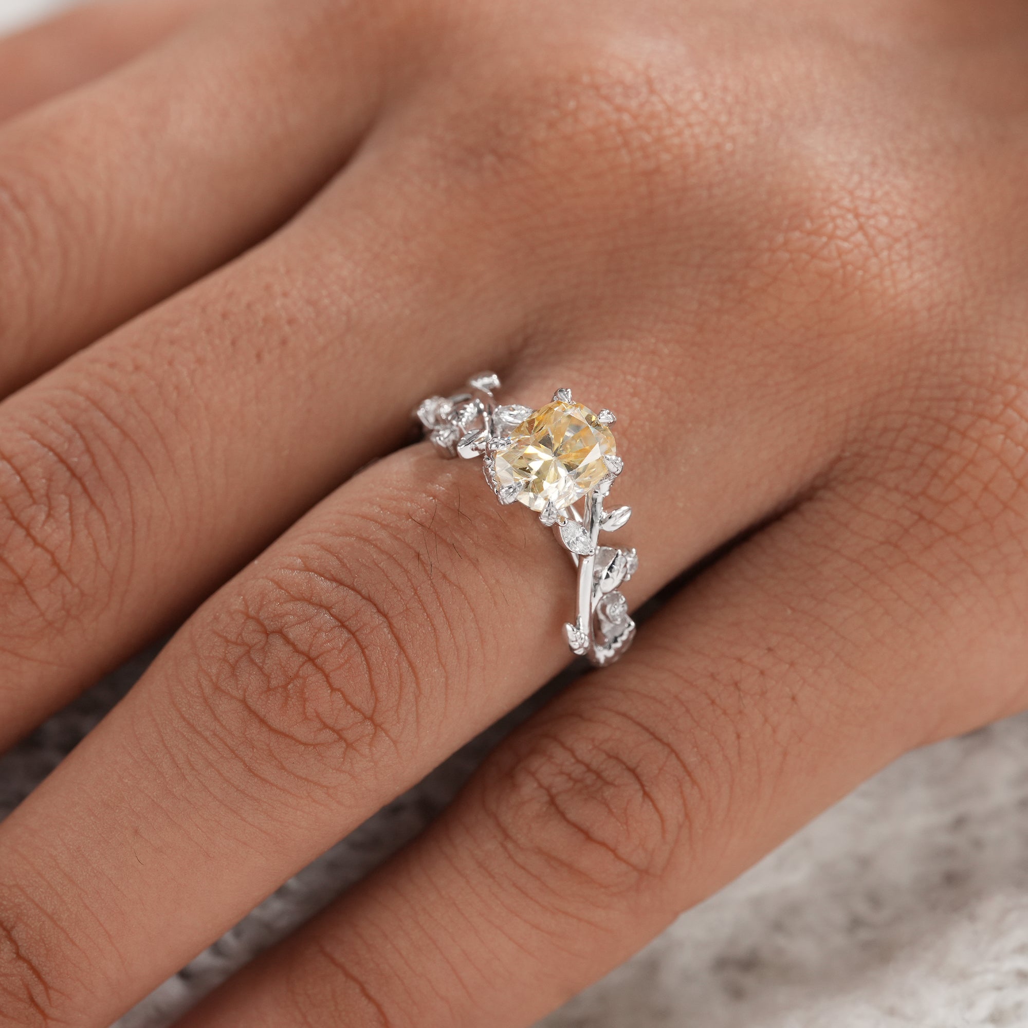 Handmade cushion cut engagement ring with nature inspired band.