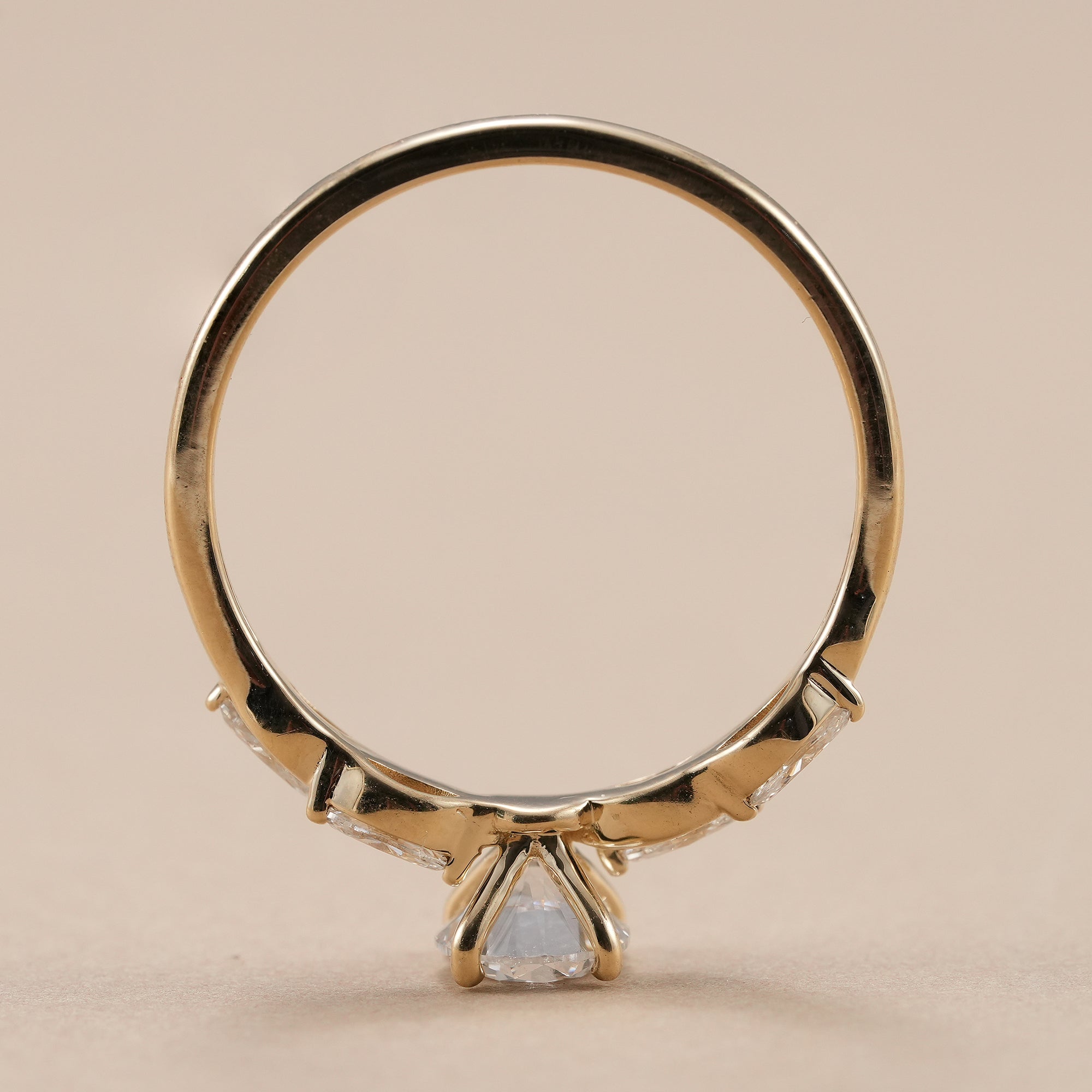 Yellow gold lab diamond engagement ring with marquise accents.