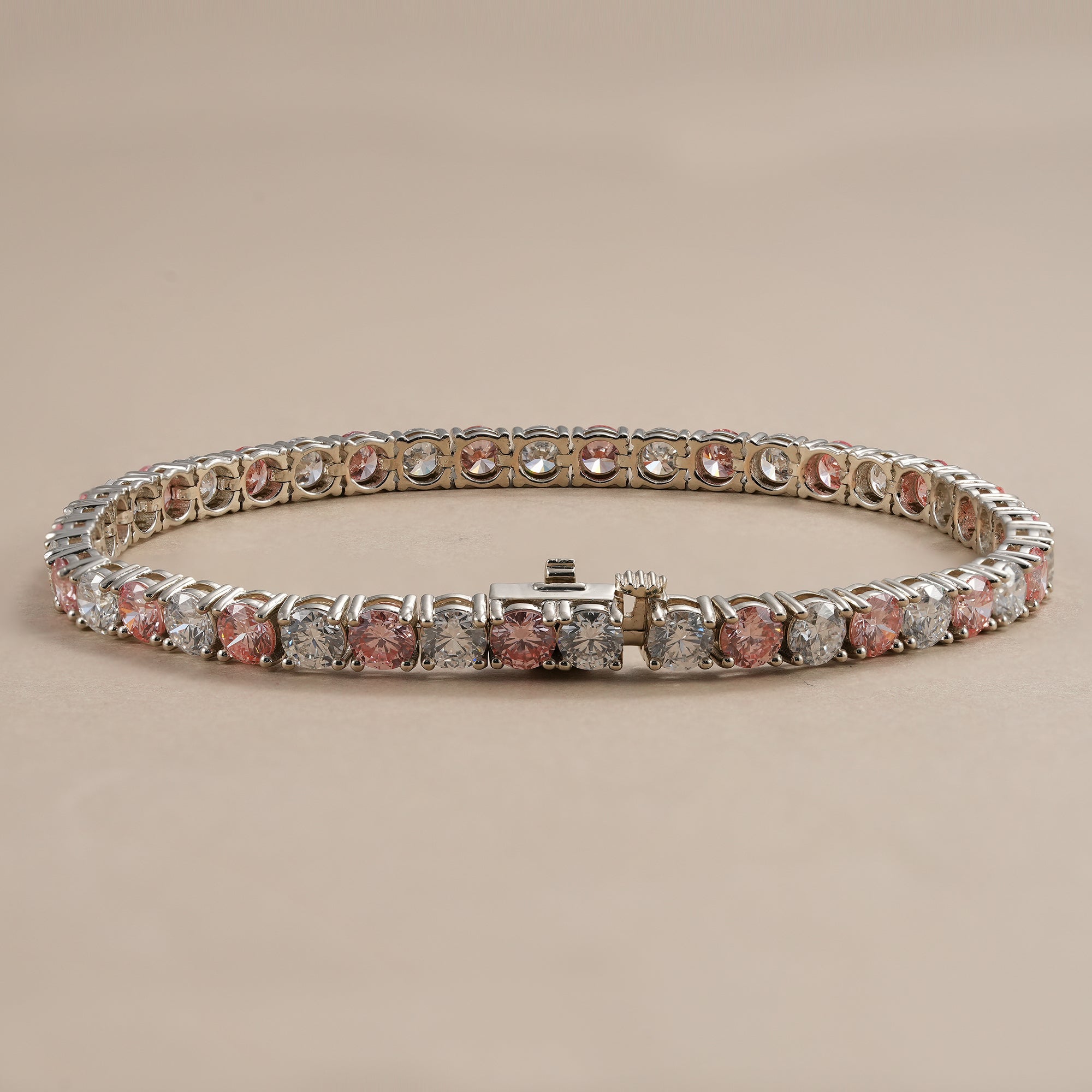 Fine jewelry tennis bracelet with pink and white lab diamonds.