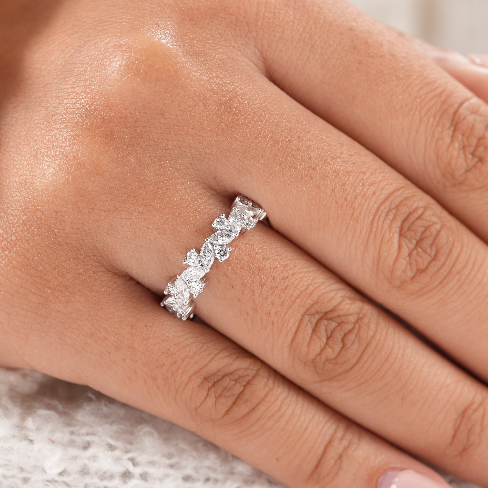 Bridal eternity ring featuring marquise and round diamond clusters.