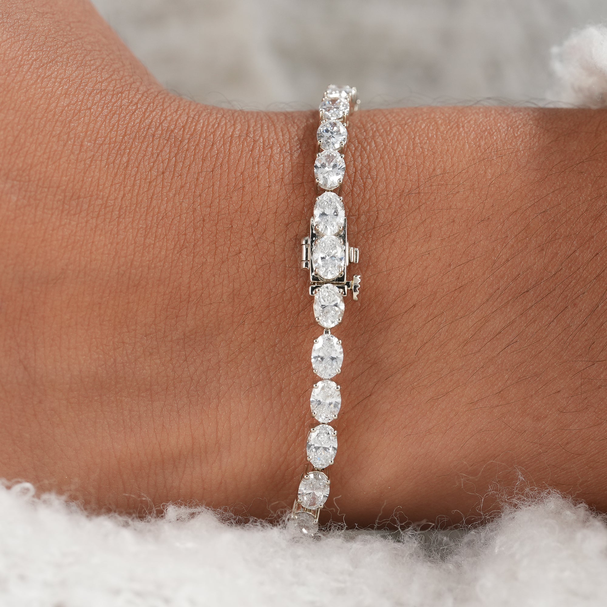 Oval cut lab grown diamond bracelet with secure box clasp.