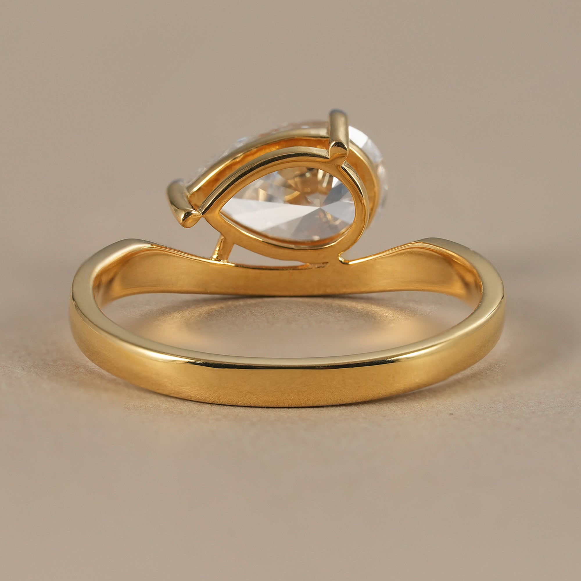 Women's pear diamond bypass ring handcrafted in gold