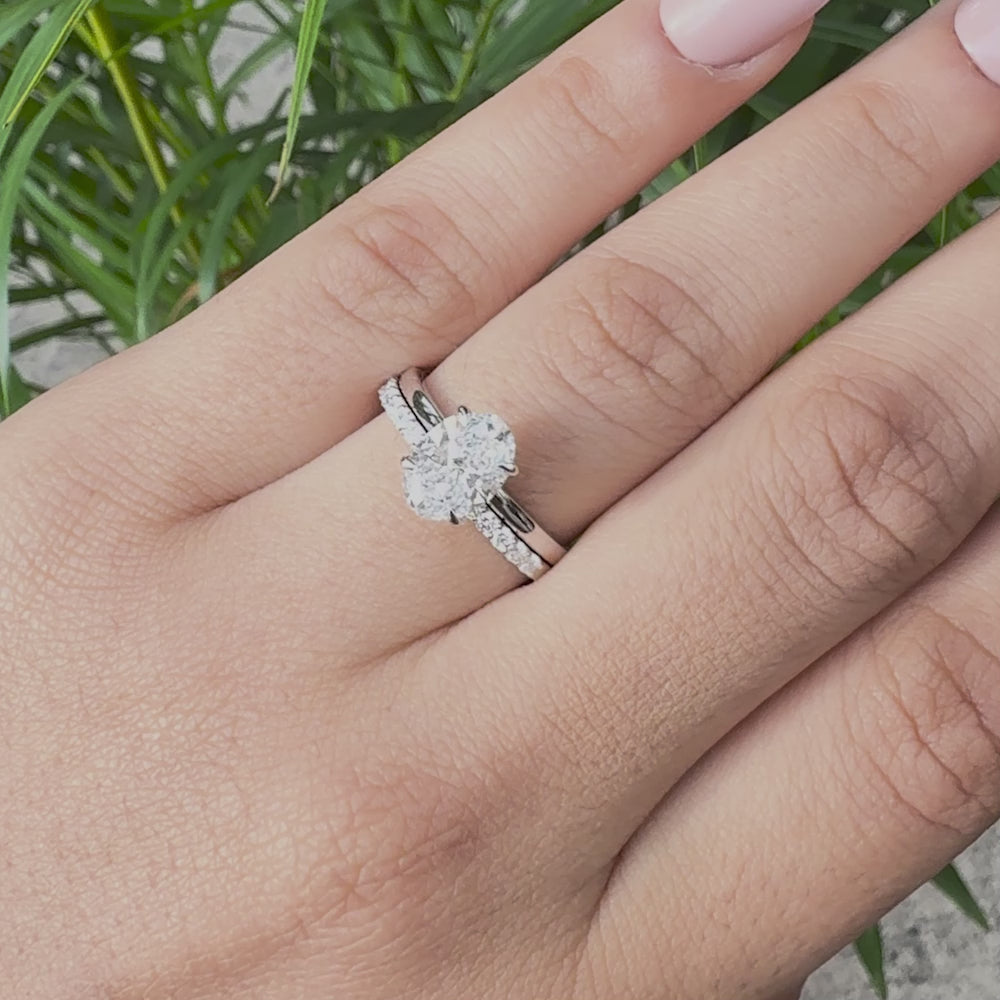 Oval diamond engagement ring and matching pavé wedding band in white gold