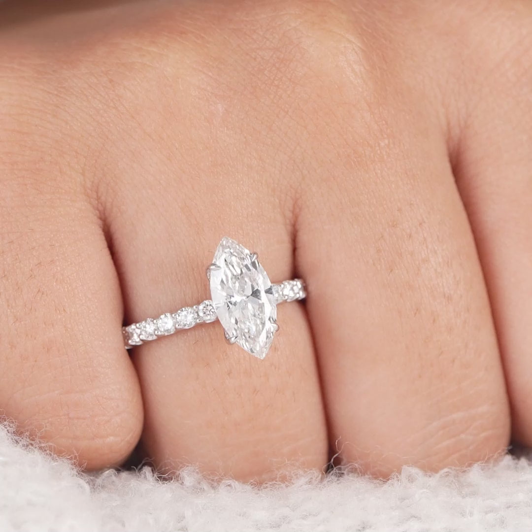 Marquise solitaire diamond ring in white gold with pavé band