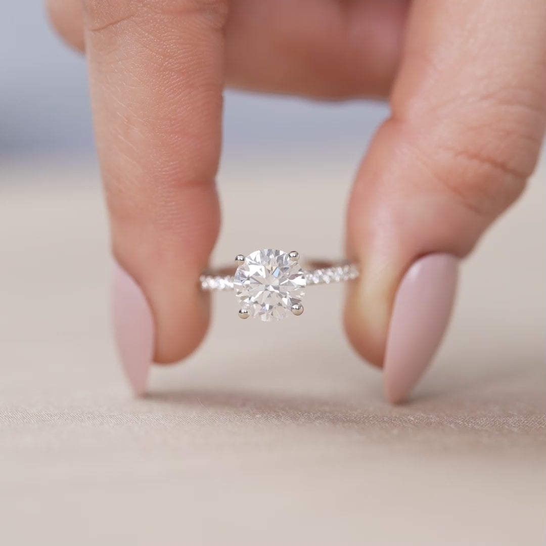 Classic round lab grown diamond ring with delicate pavé shoulders